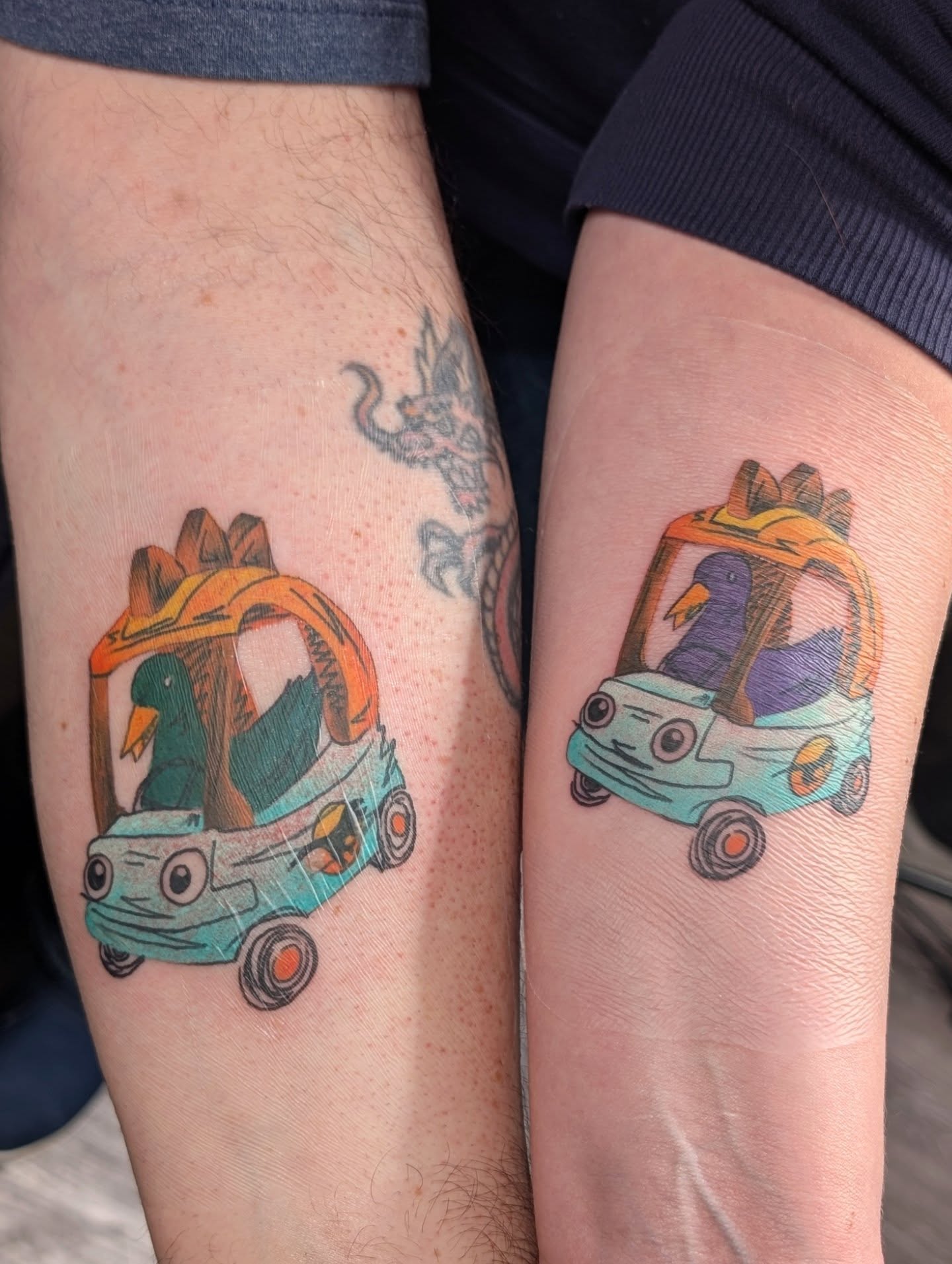 Duck driving car new school tattoo on the forearm by Michaela May