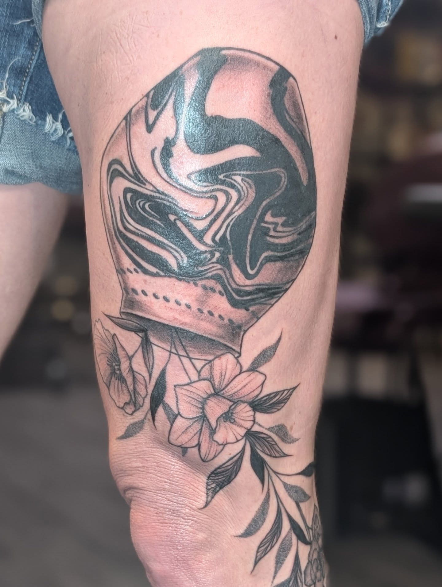 Abstract swirl with flowers black and grey tattoo on the forearm by Michaela May