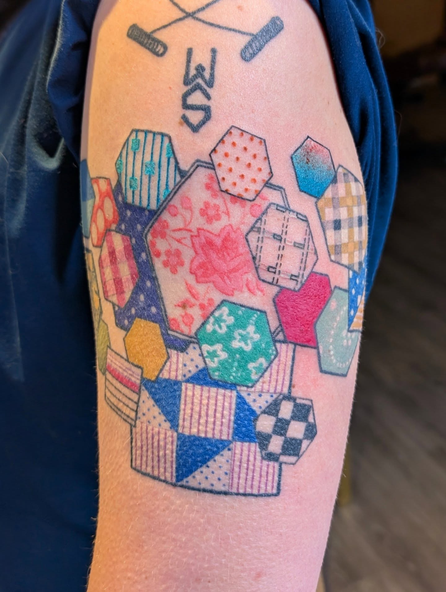 Patchwork quilt geometric tattoo on the forearm by Michaela May