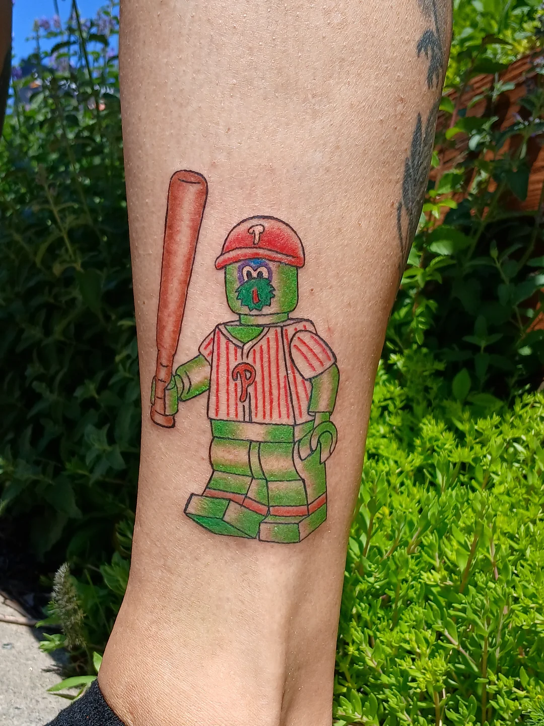 Baseball player illustrative tattoo on the forearm by Amber Tattoos