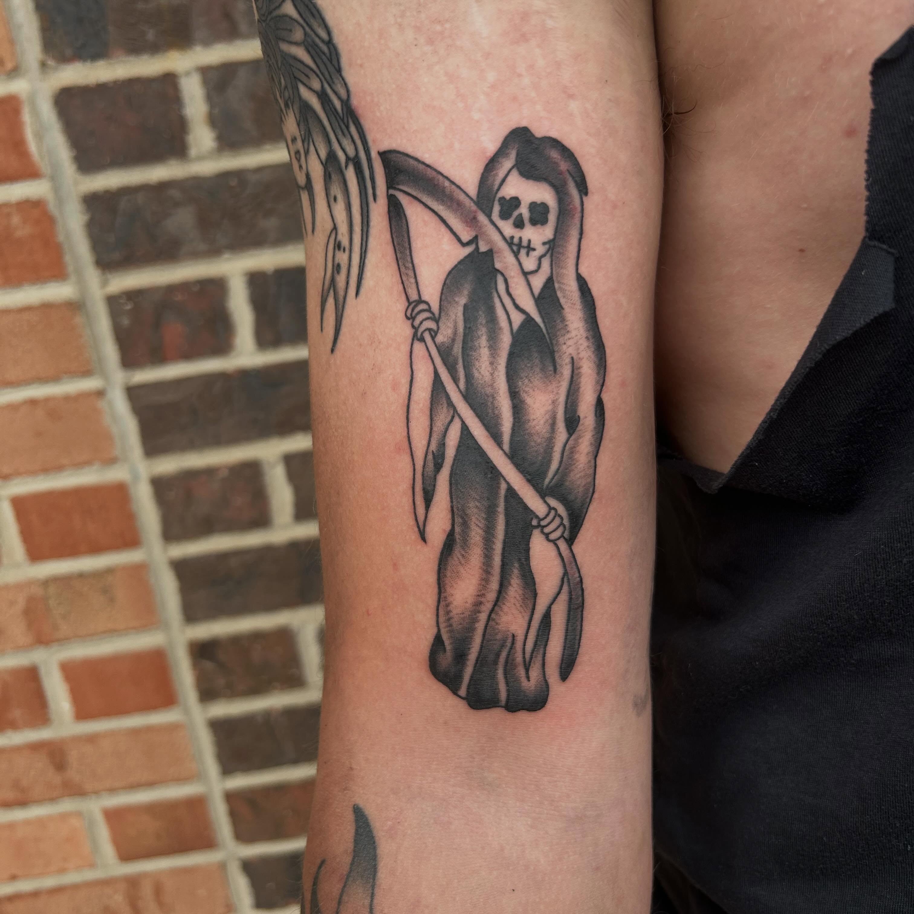 Grim reaper black and grey tattoo on the forearm by Zach Andrews