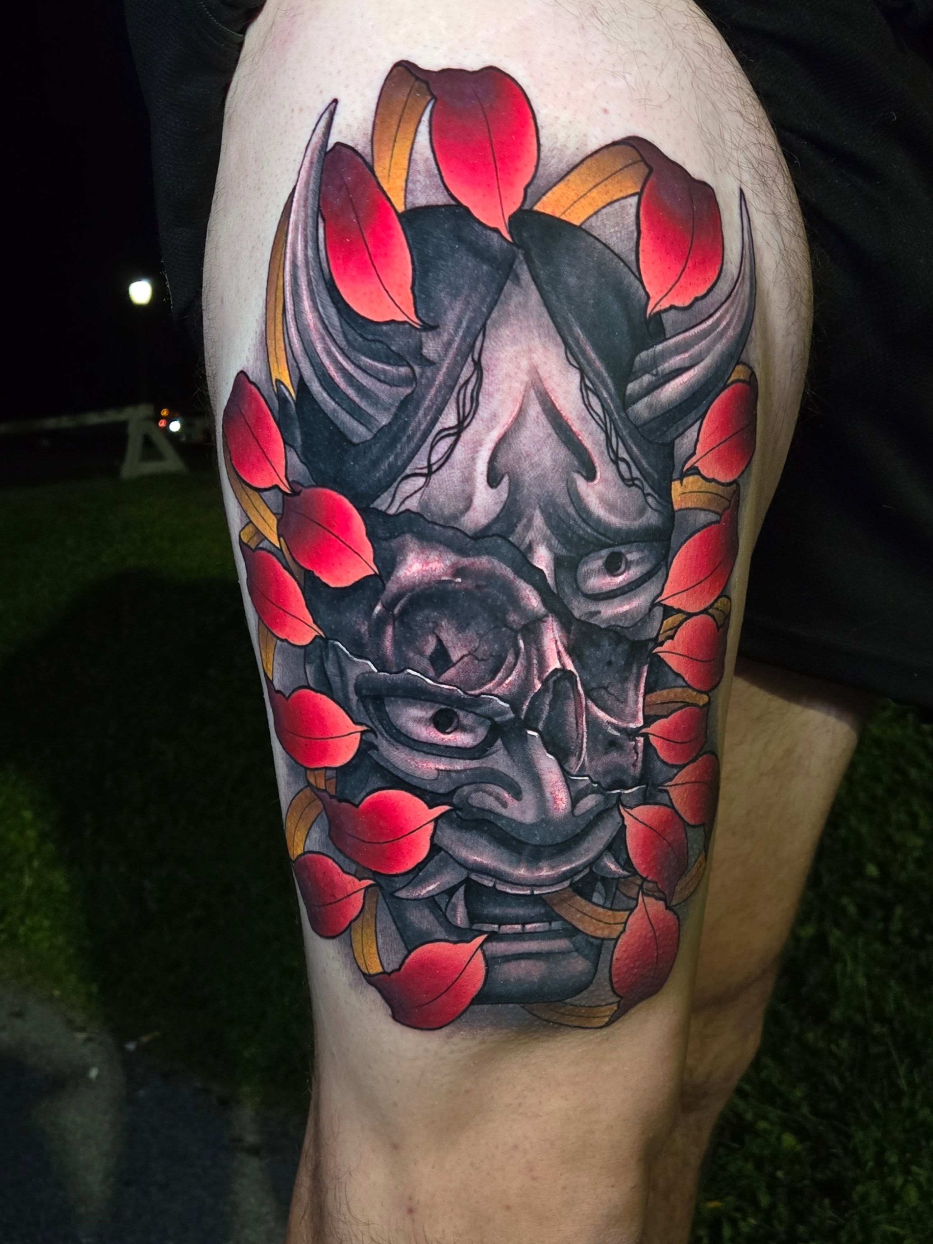 Mask with leaves japanese irezumi tattoo on the thigh by Jeff Stager