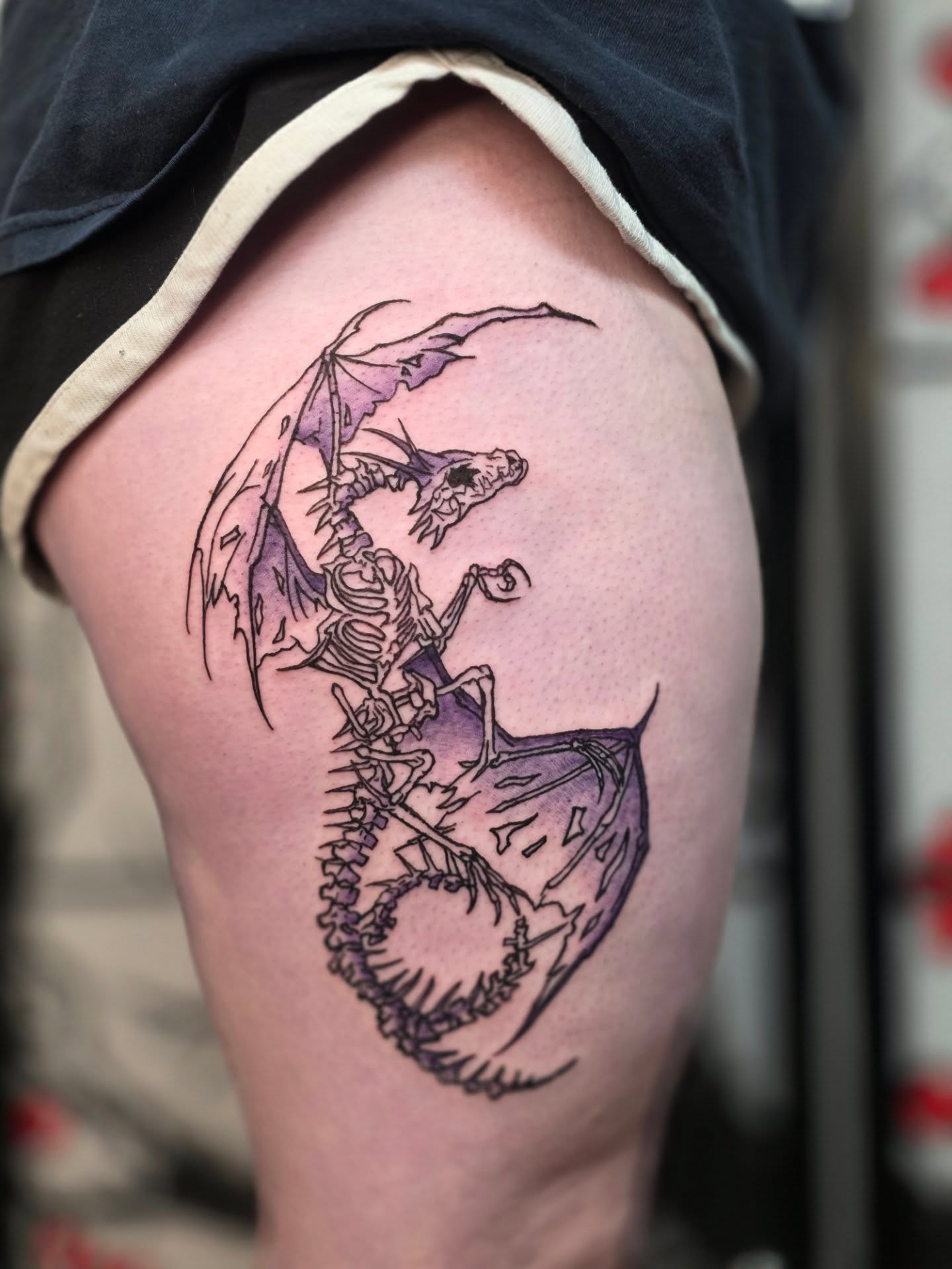 Dragon skeleton dotwork tattoo on the thigh by Bryan "Yogi" Fuhs