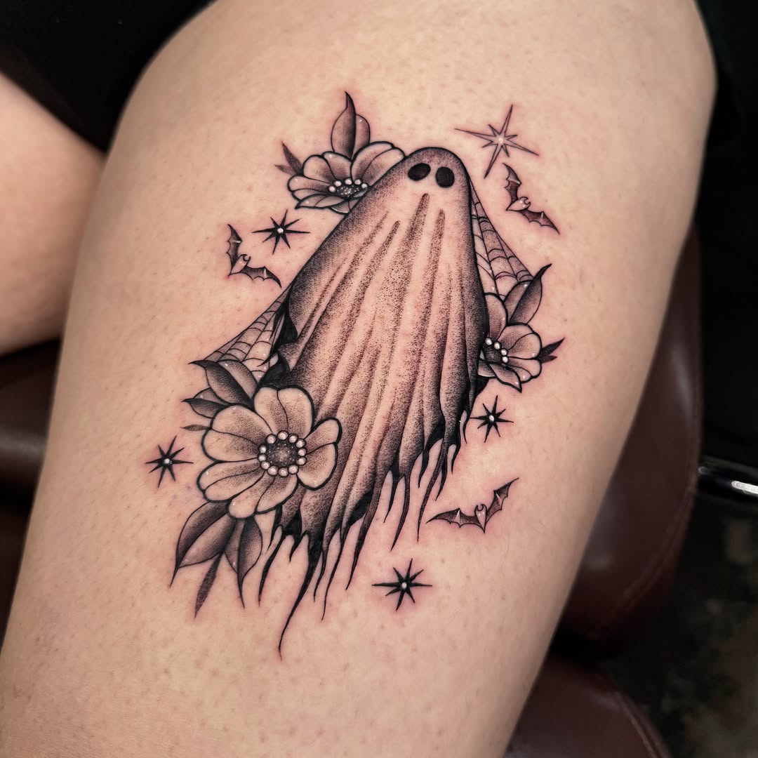 Ghost with flowers black and grey tattoo on the thigh by Alexia
