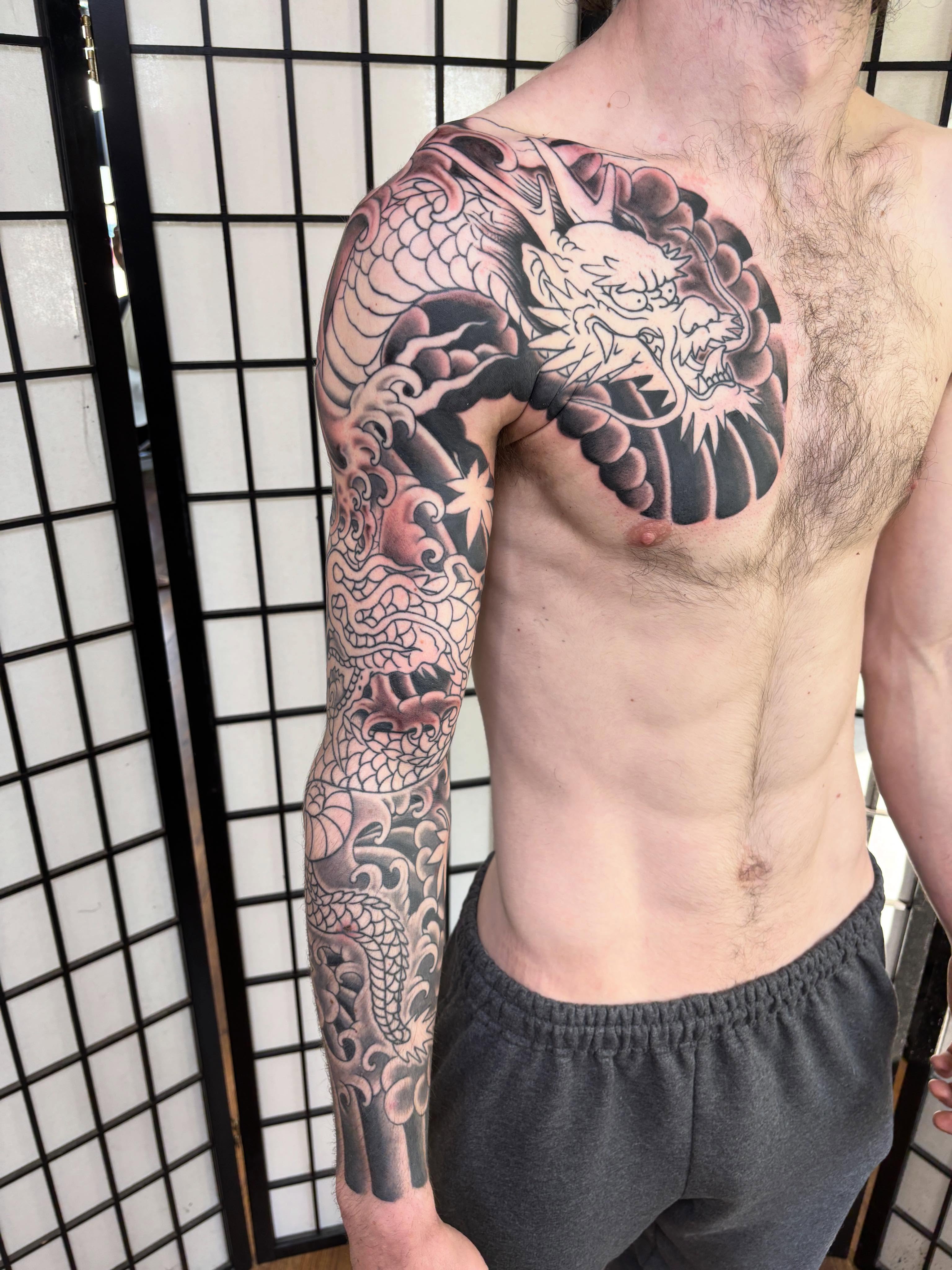 Dragon japanese irezumi tattoo on the upper arm by Mike DiCicco