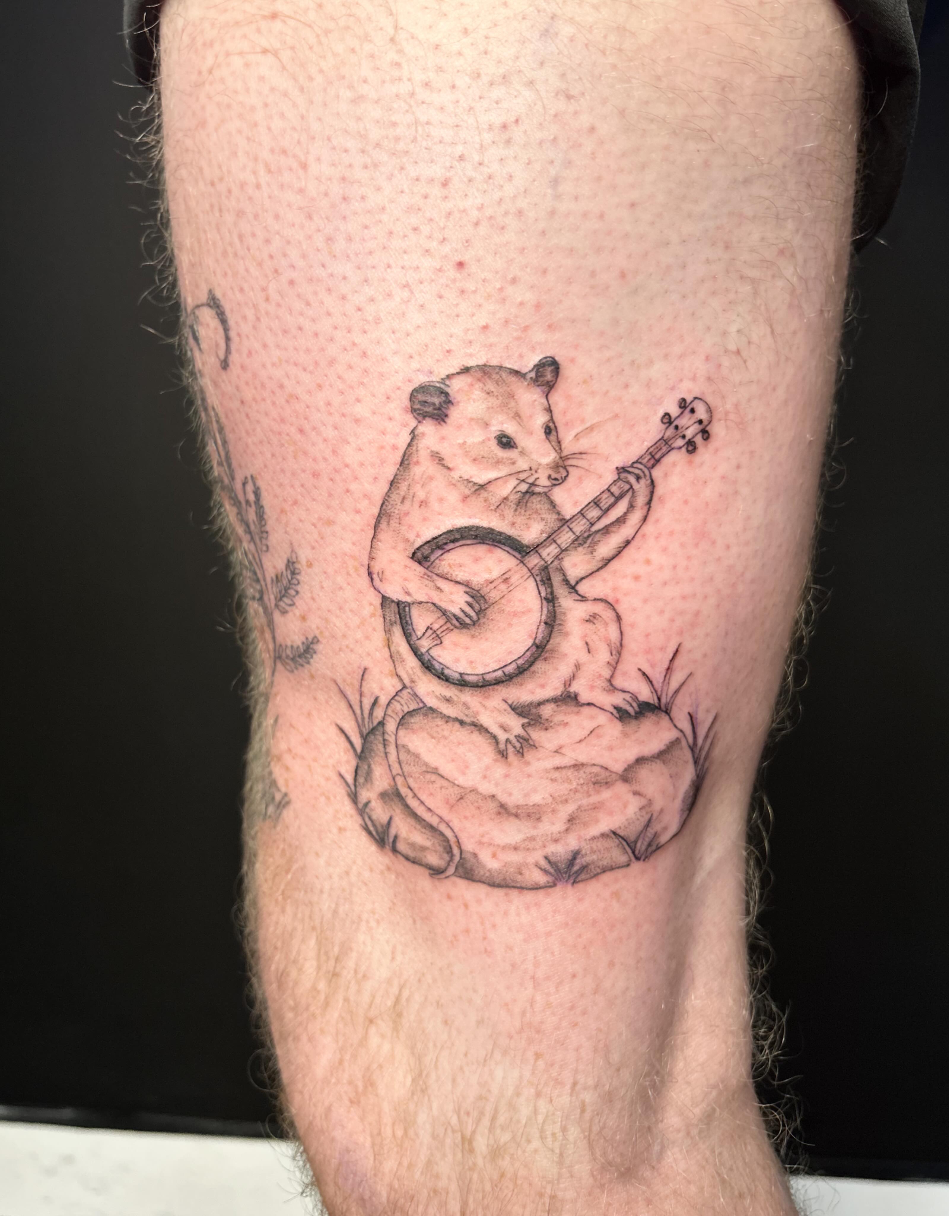 Mouse playing guitar realism tattoo on the forearm by Elizabeth (Lib), Murfreesboro, Tennessee