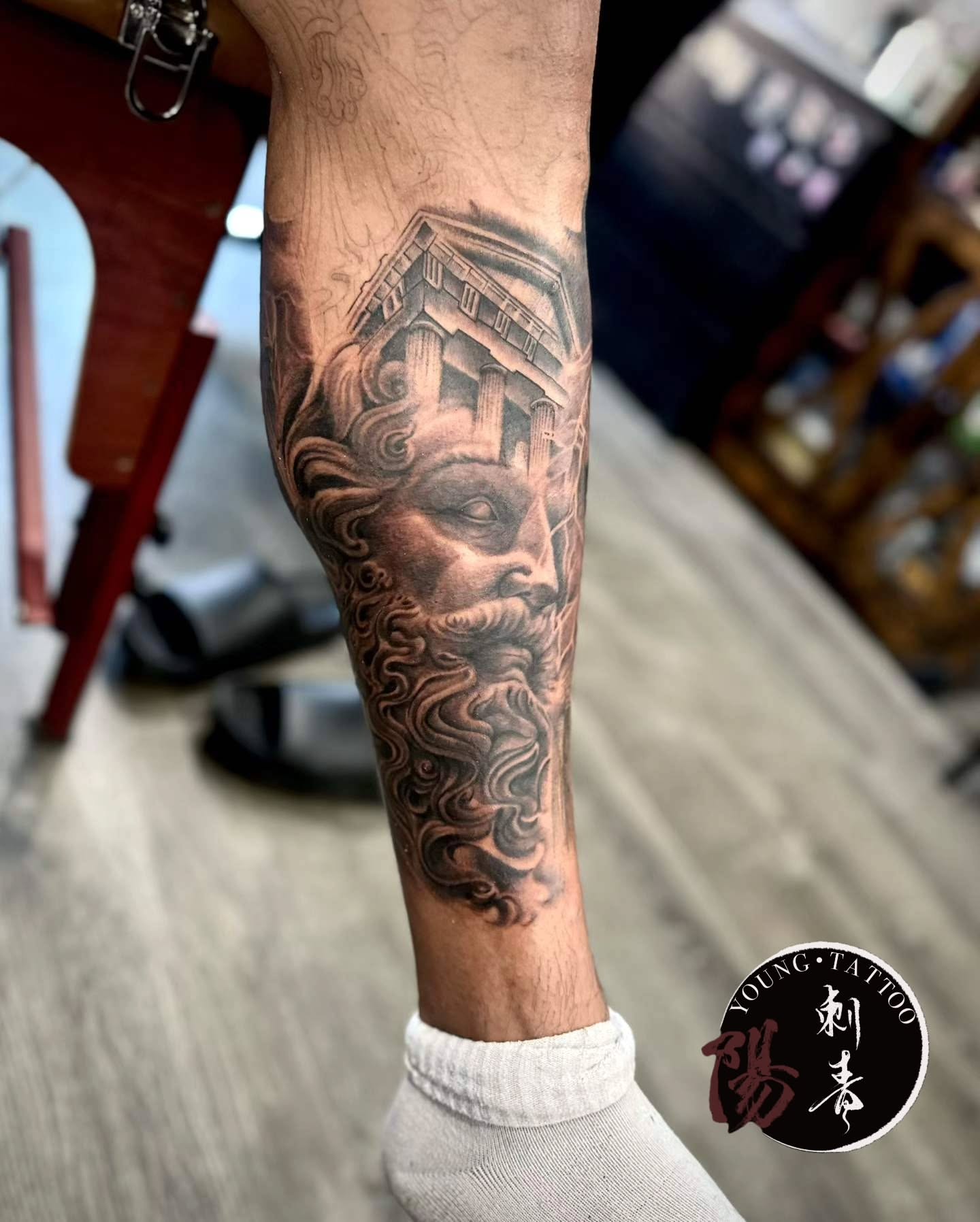 God-like figure realism tattoo on the forearm by Ying