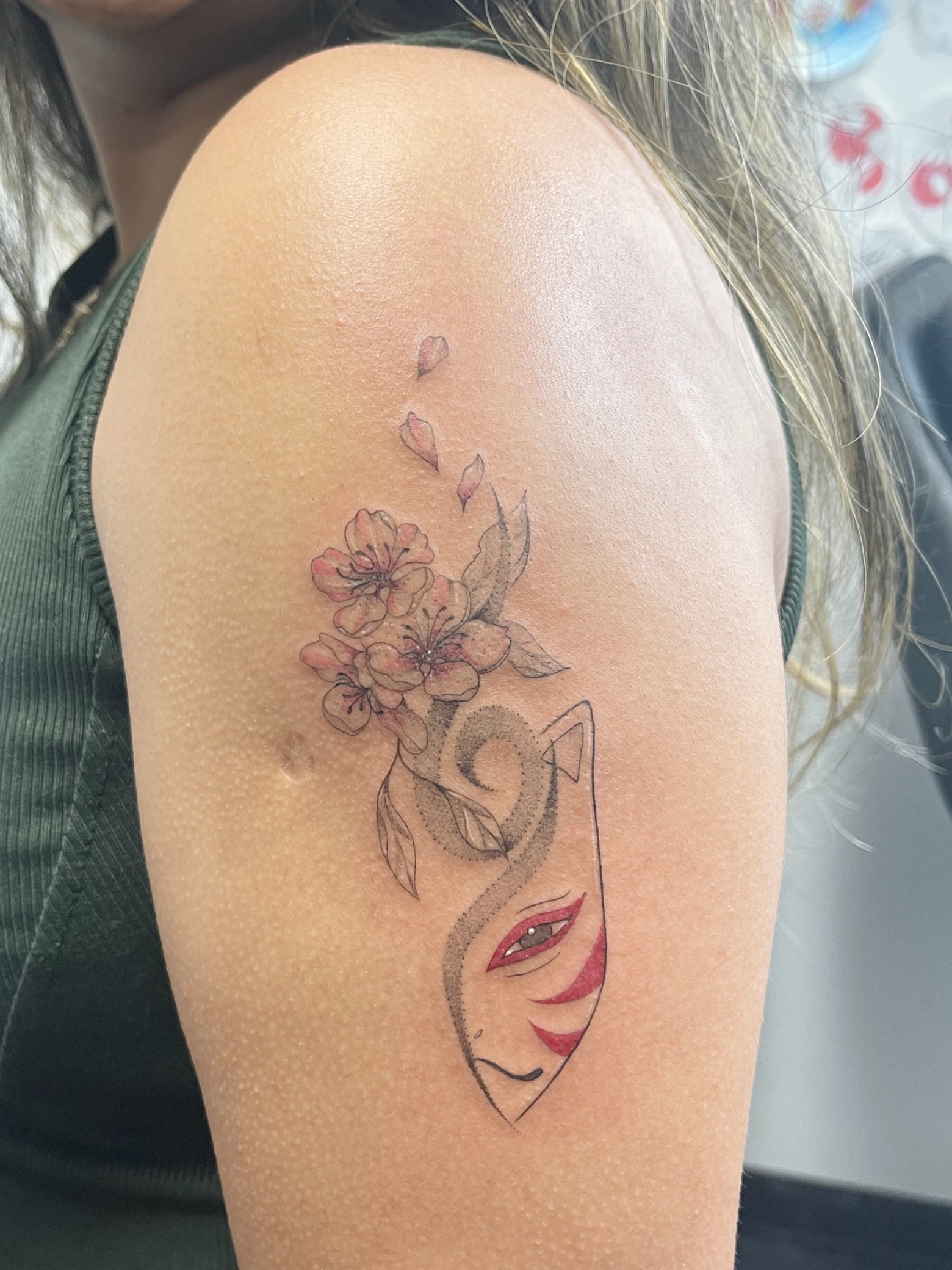 Woman's face with flowers dotwork tattoo on the shoulder by Sid