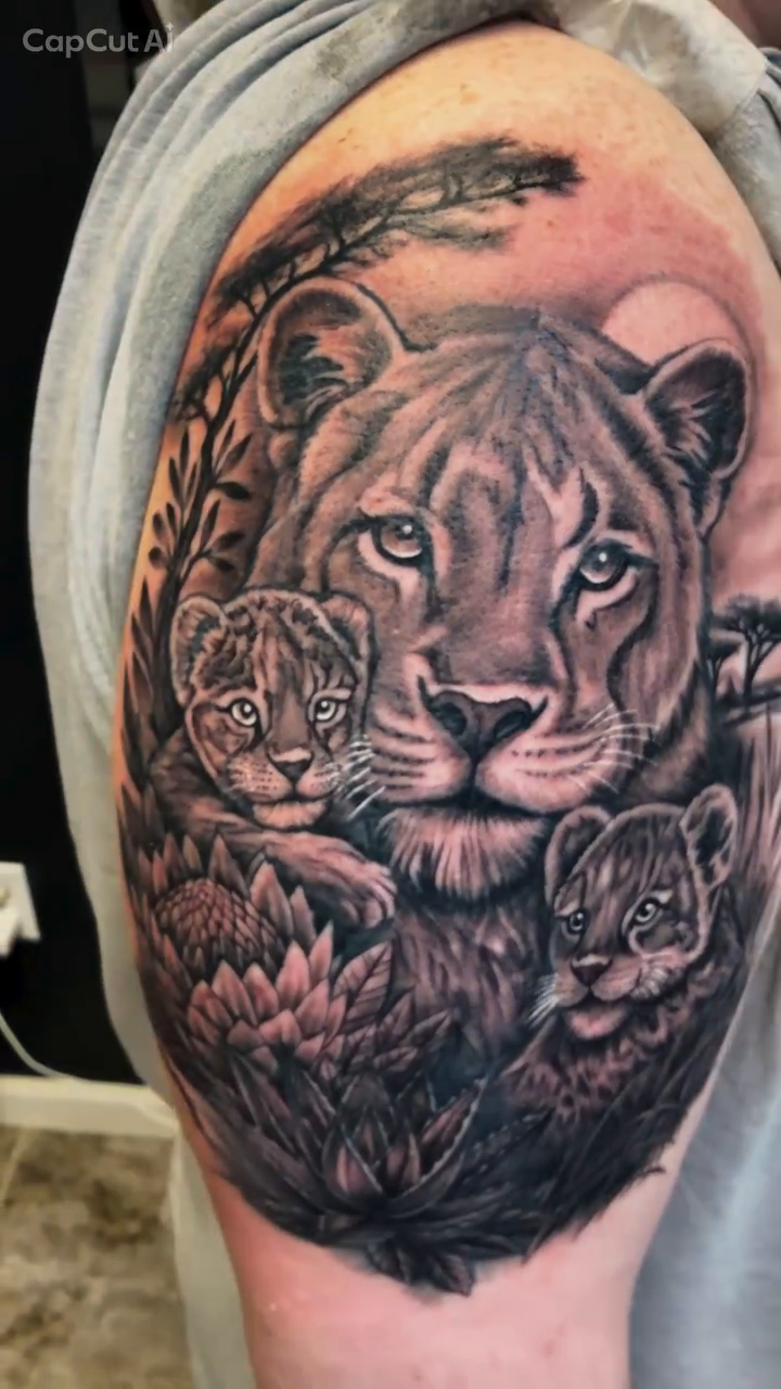 Lioness with cubs realism tattoo on the shoulder by 𝔻𝕖𝕣𝕣𝕚𝕔𝕜 𝔹𝕦𝕪𝕖𝕒, East Aurora, New York