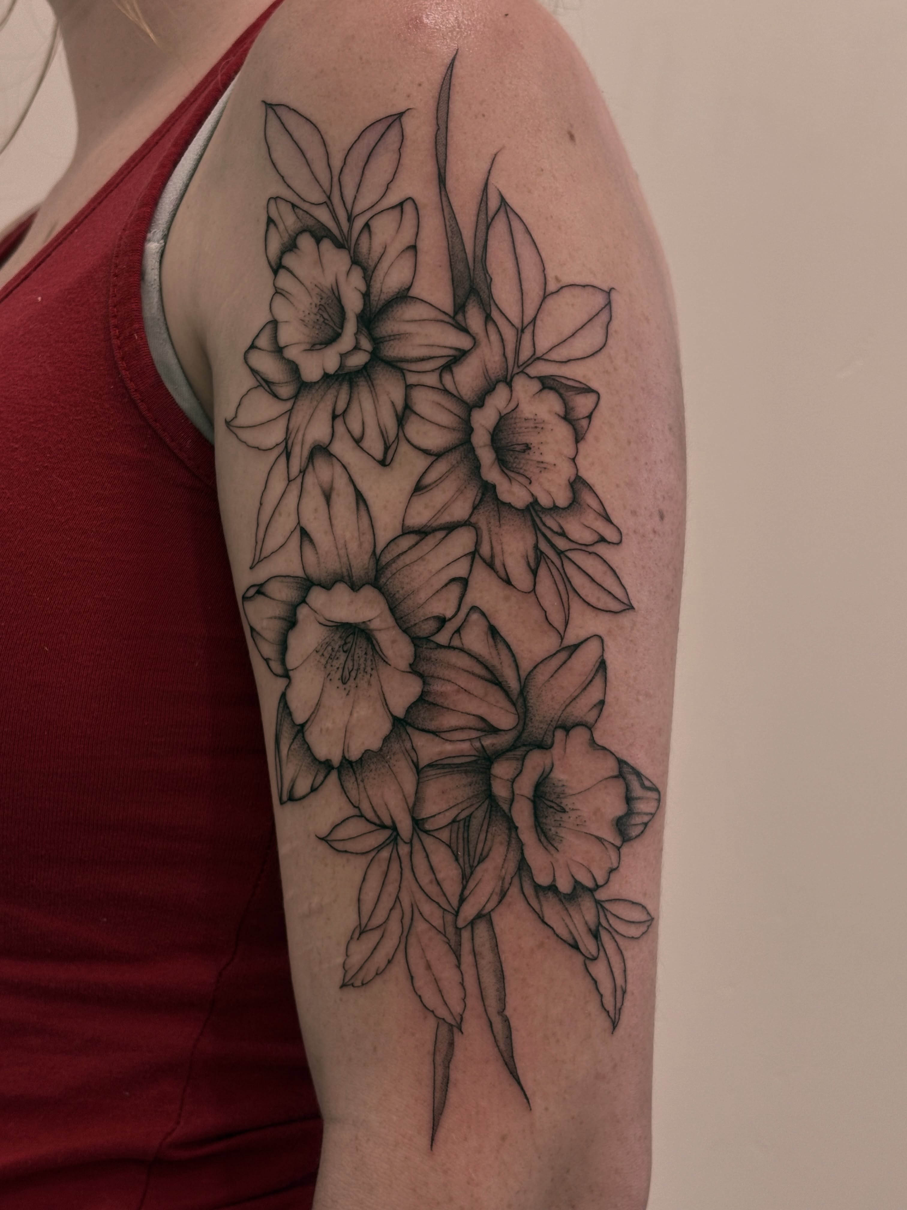 Flowers black and grey tattoo on the upper arm by Tayler, Tooele, Utah