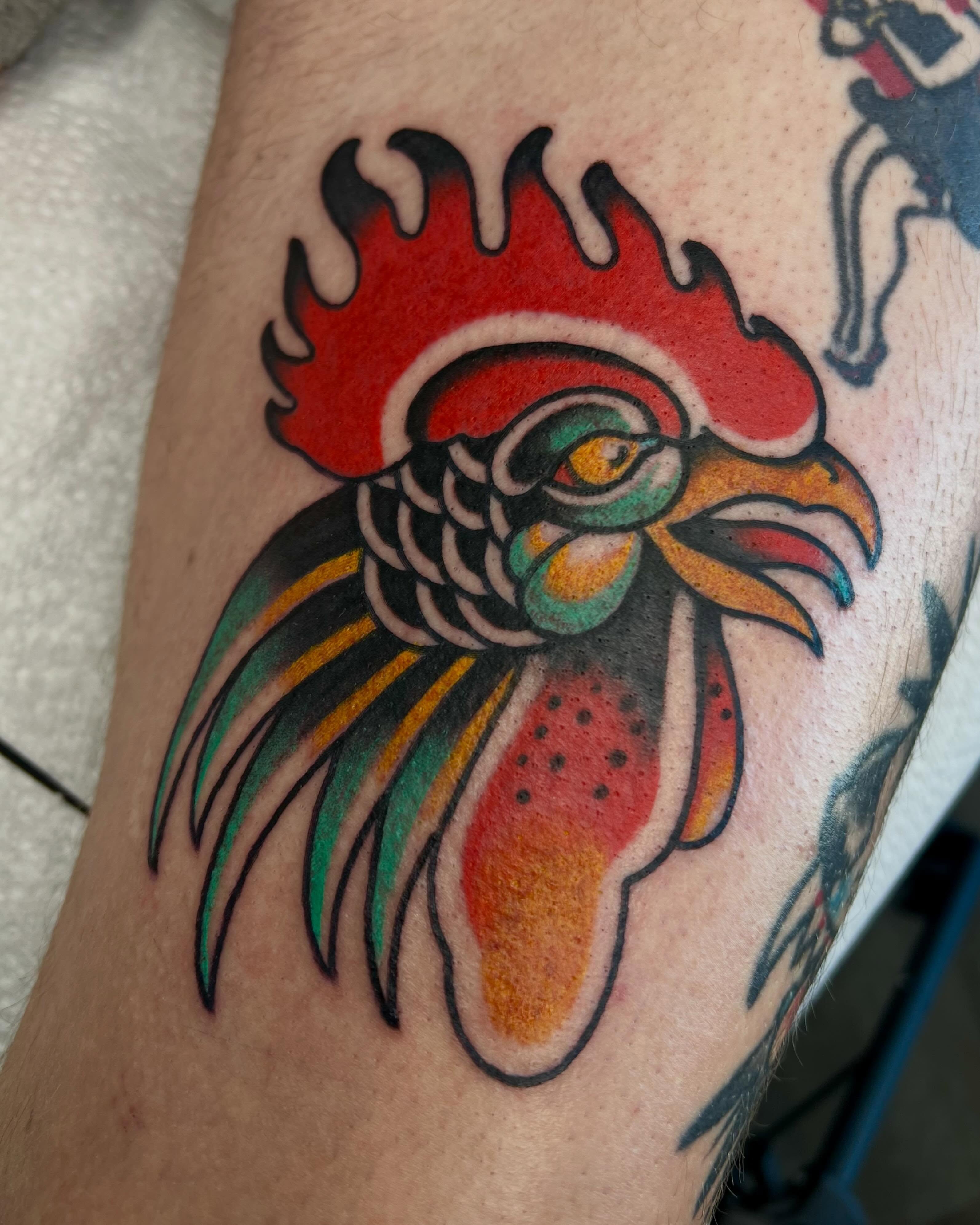 Rooster American traditional tattoo on the forearm by Brandon McDaniel Iowa Tattoo Artist