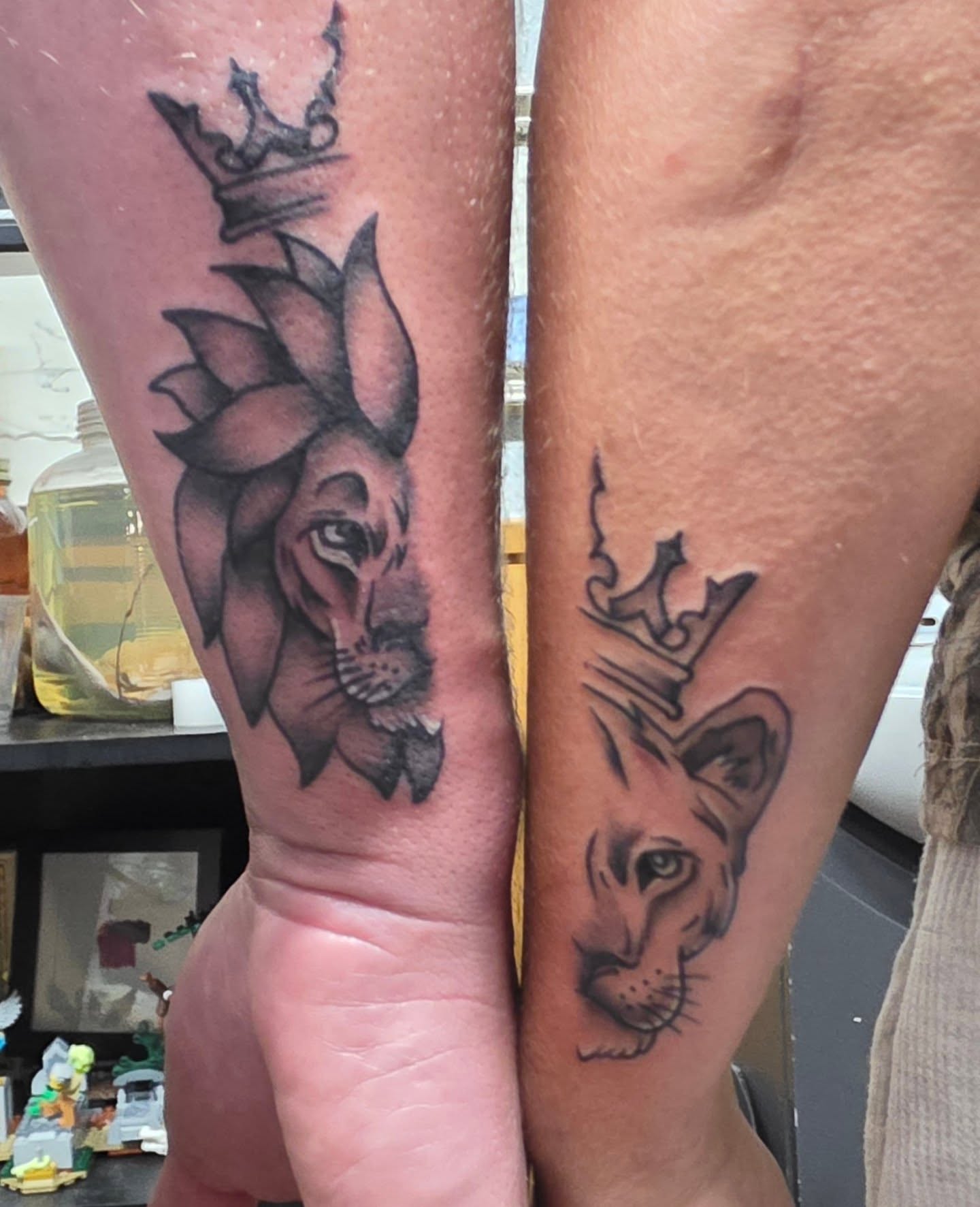 Lion crown black and grey tattoo on the forearm by Moe