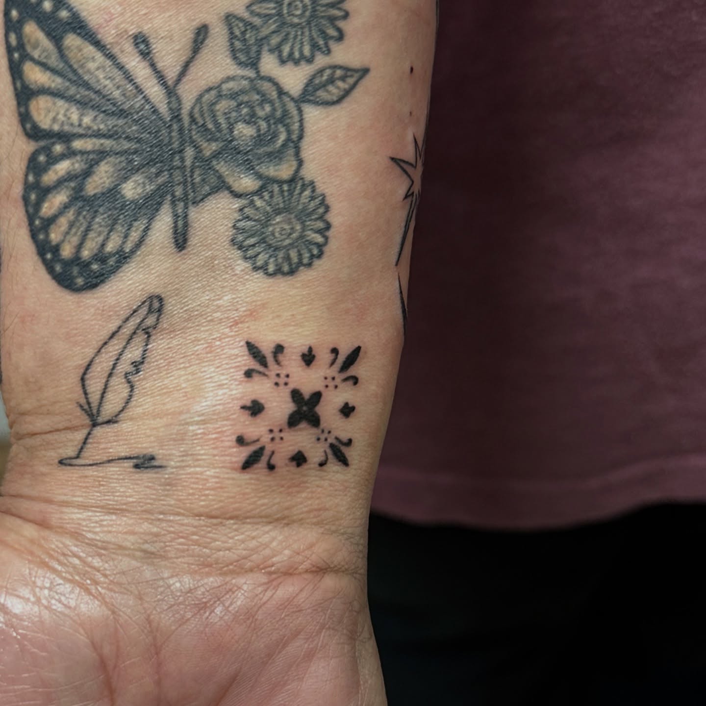Butterfly and floral black and grey tattoo on the forearm by Jocelyn