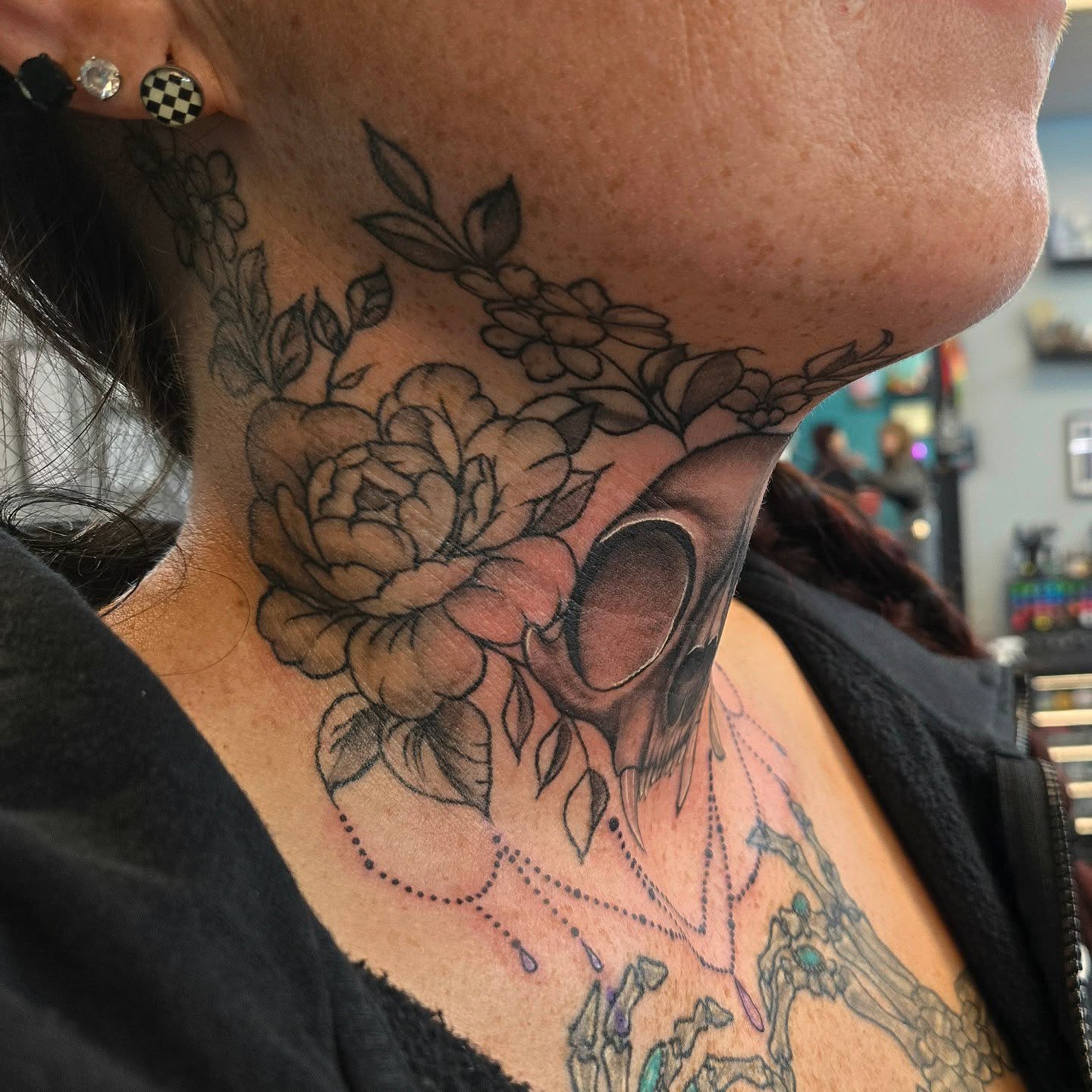 Floral skull dotwork tattoo on the neck by Danielle Elizabeth