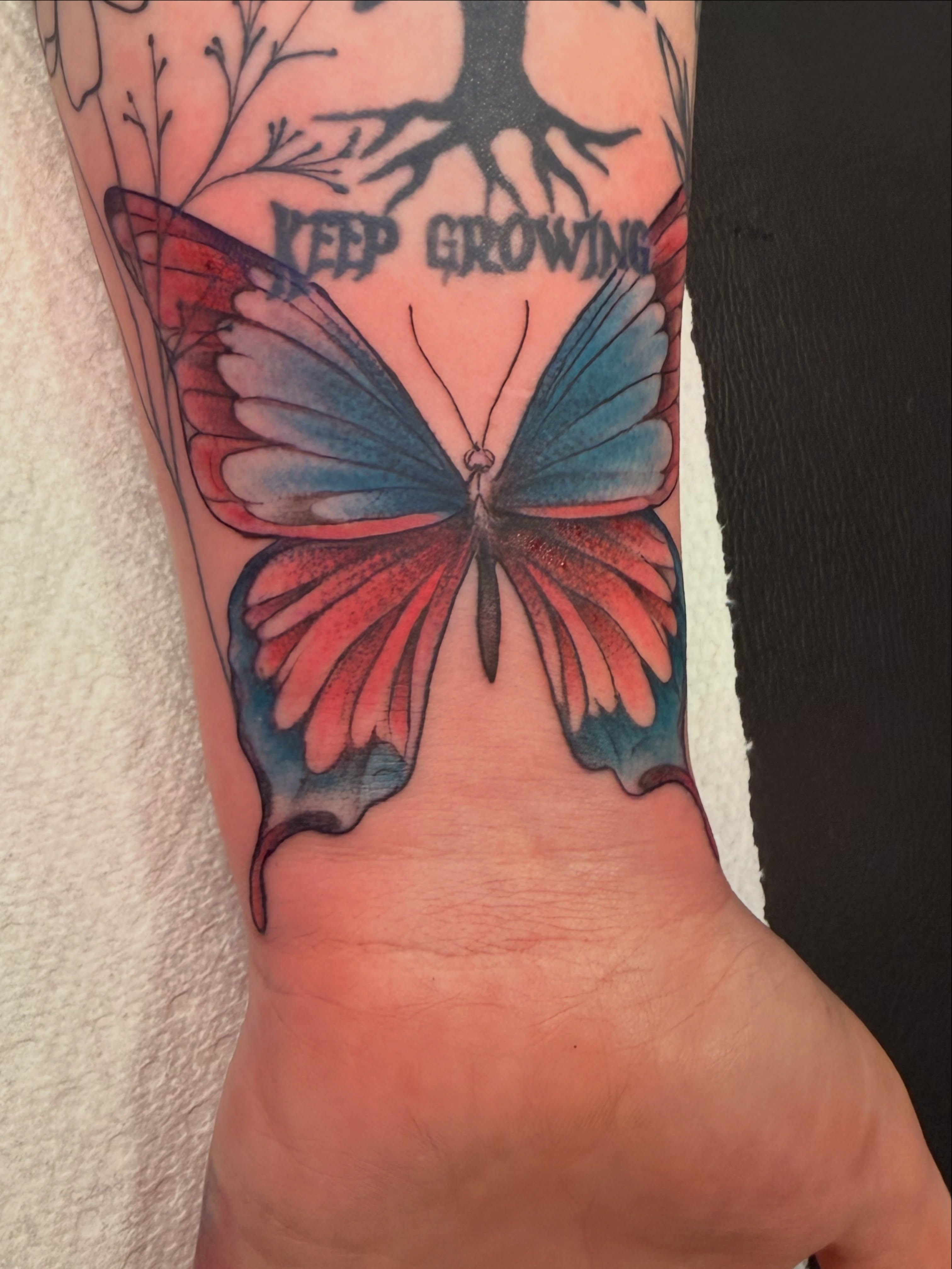 Butterfly watercolor tattoo on the forearm by Butta