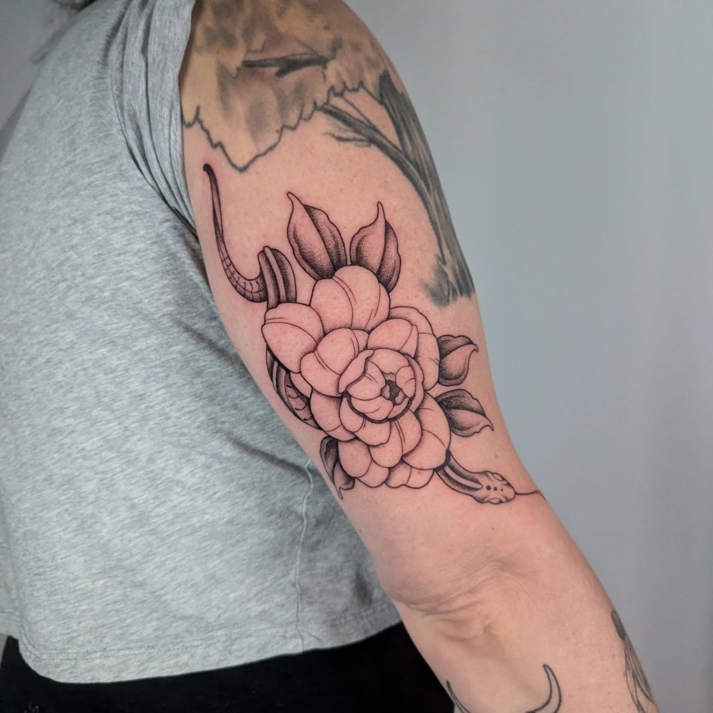 Peony and snake black and grey tattoo on the forearm by Courtney Yaddof