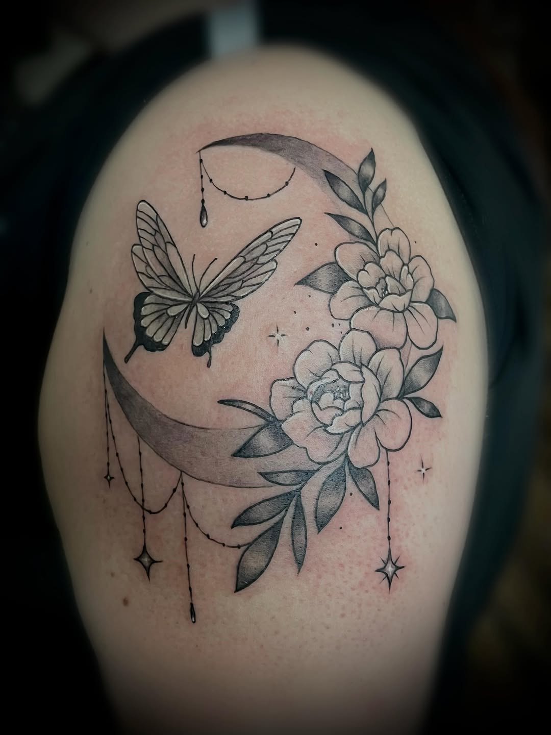 Moon with butterfly and flowers fine line tattoo on the shoulder by Saint