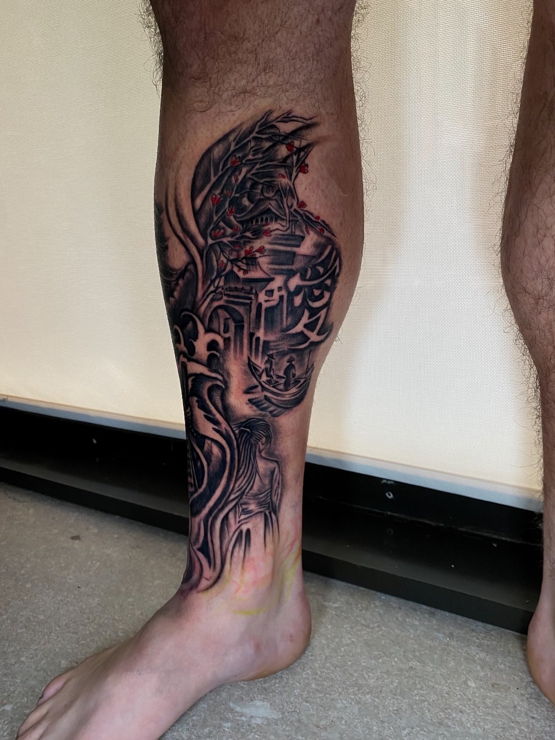Cyborg dark realism tattoo on the calf by Kelan Mckenna