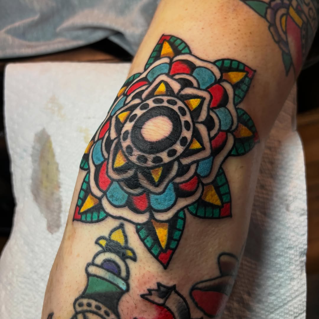Mandala American traditional tattoo on the forearm by Mitch Ashpaugh