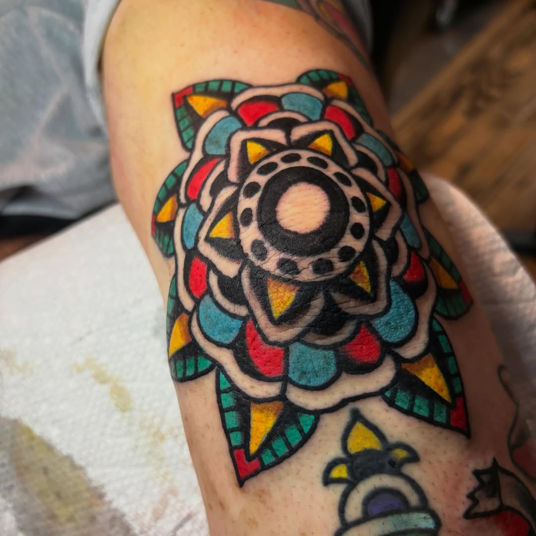 Mandala American traditional tattoo on the forearm by Mitch Ashpaugh