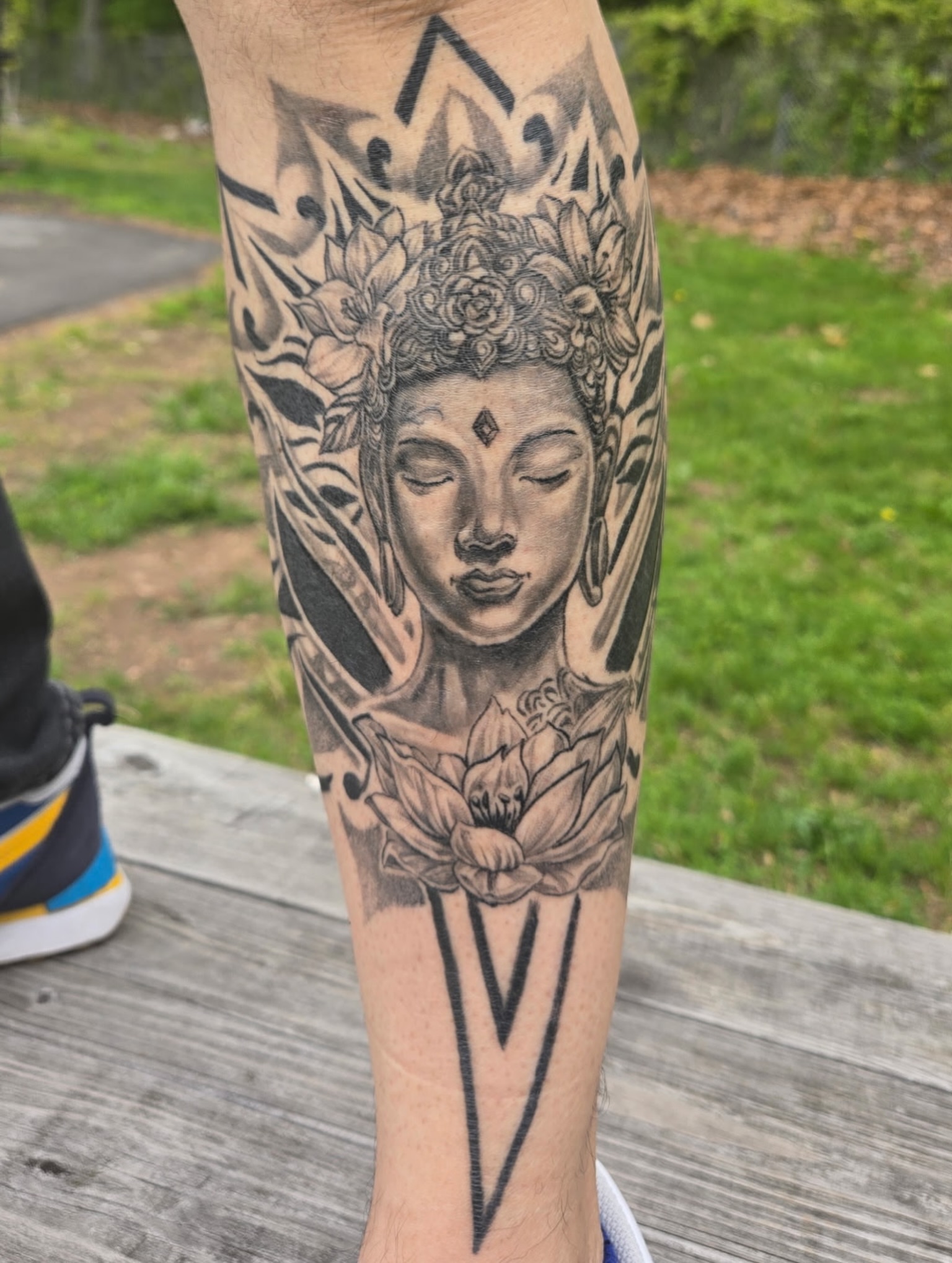 Buddha-like figure geometric tattoo on the forearm by Simón, Newington, Connecticut
