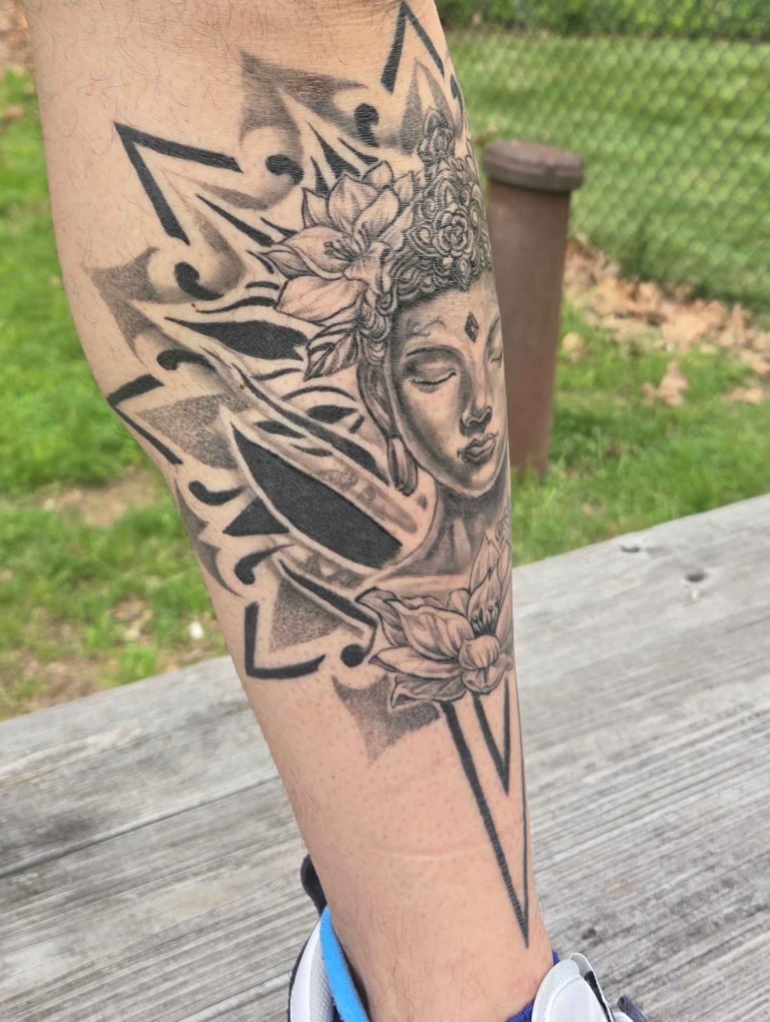 Lotus flower and Buddha realism tattoo on the forearm by Simón, Newington, Connecticut