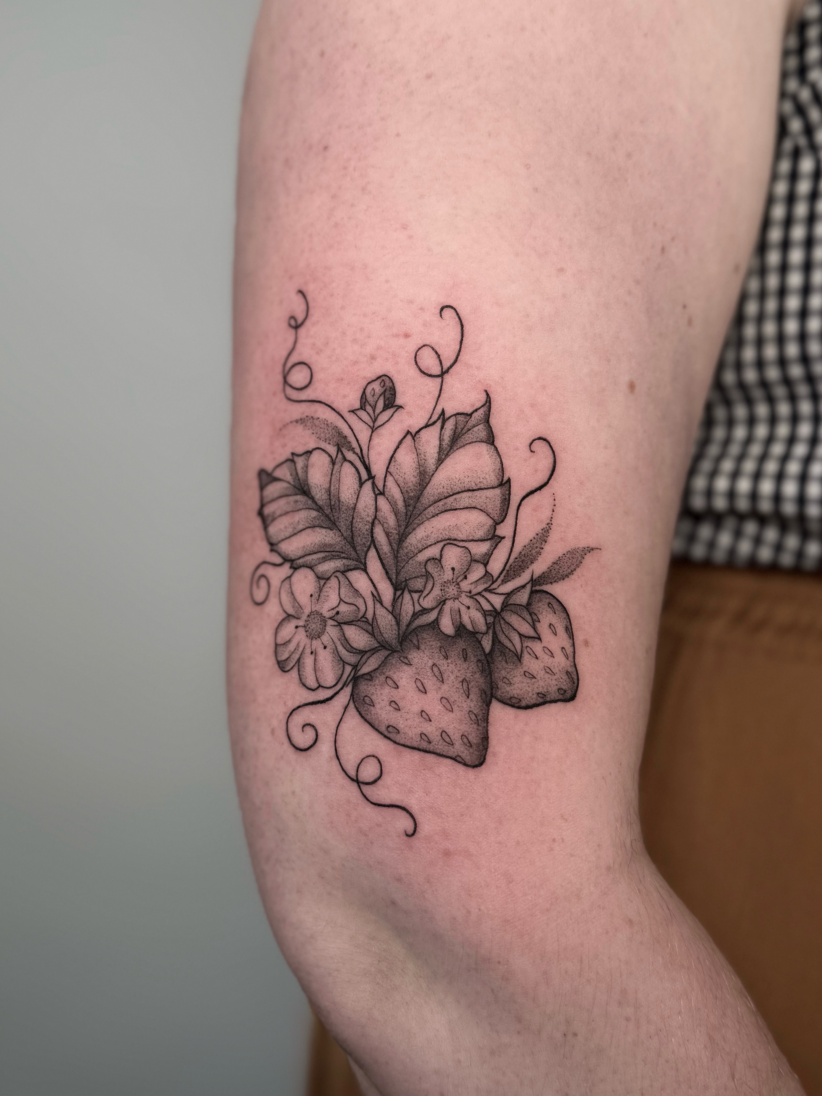 Strawberry bouquet realism tattoo on the forearm by Jessica Bloom
