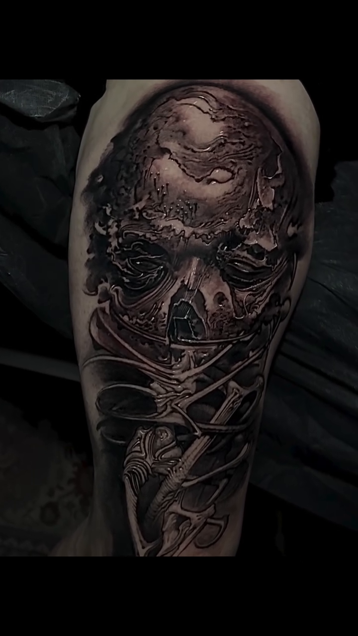 Skull with mechanical elements dark realism tattoo by Robert Hernandez