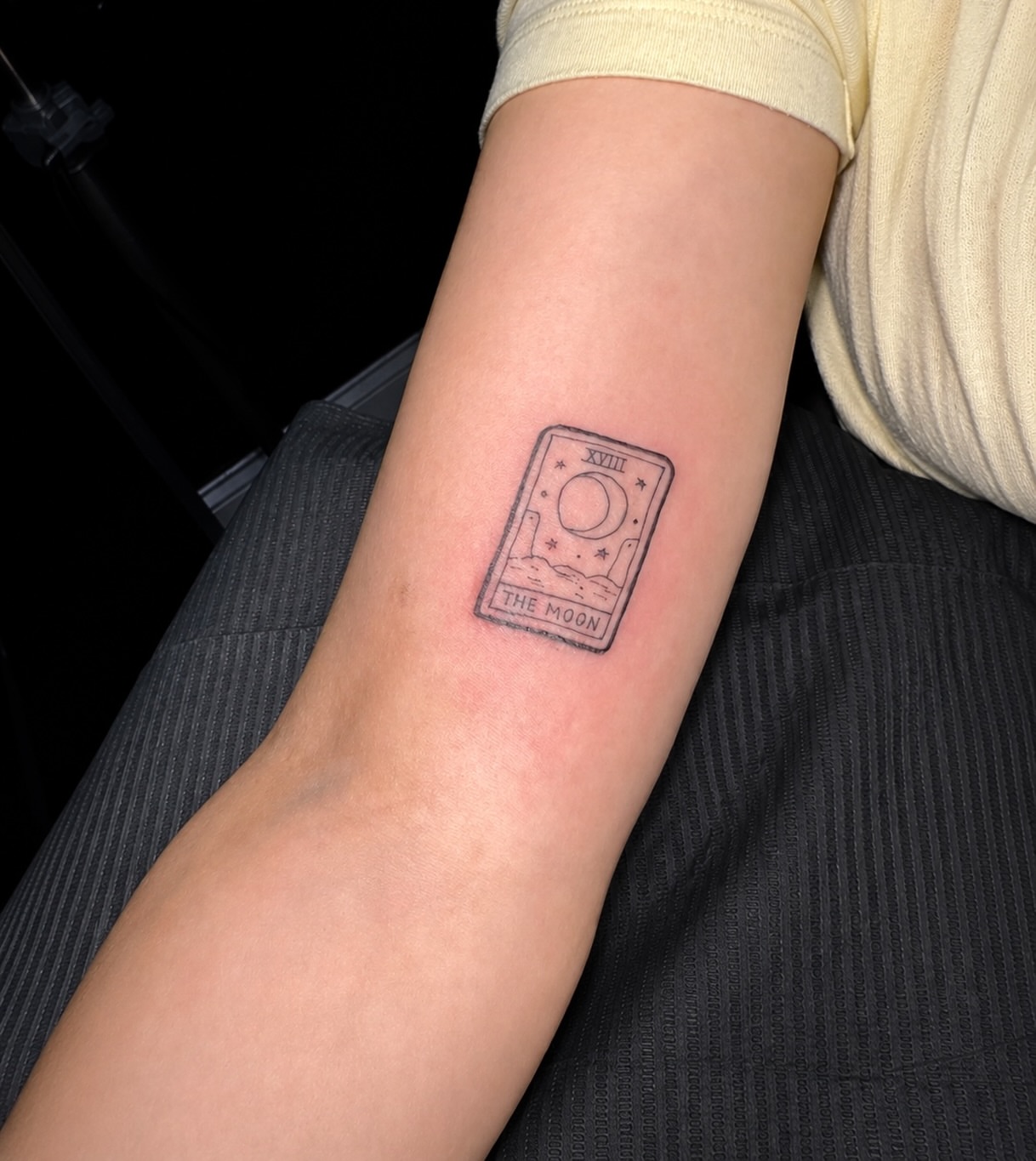 The moon tarot card black and grey tattoo on the forearm by Nicole
