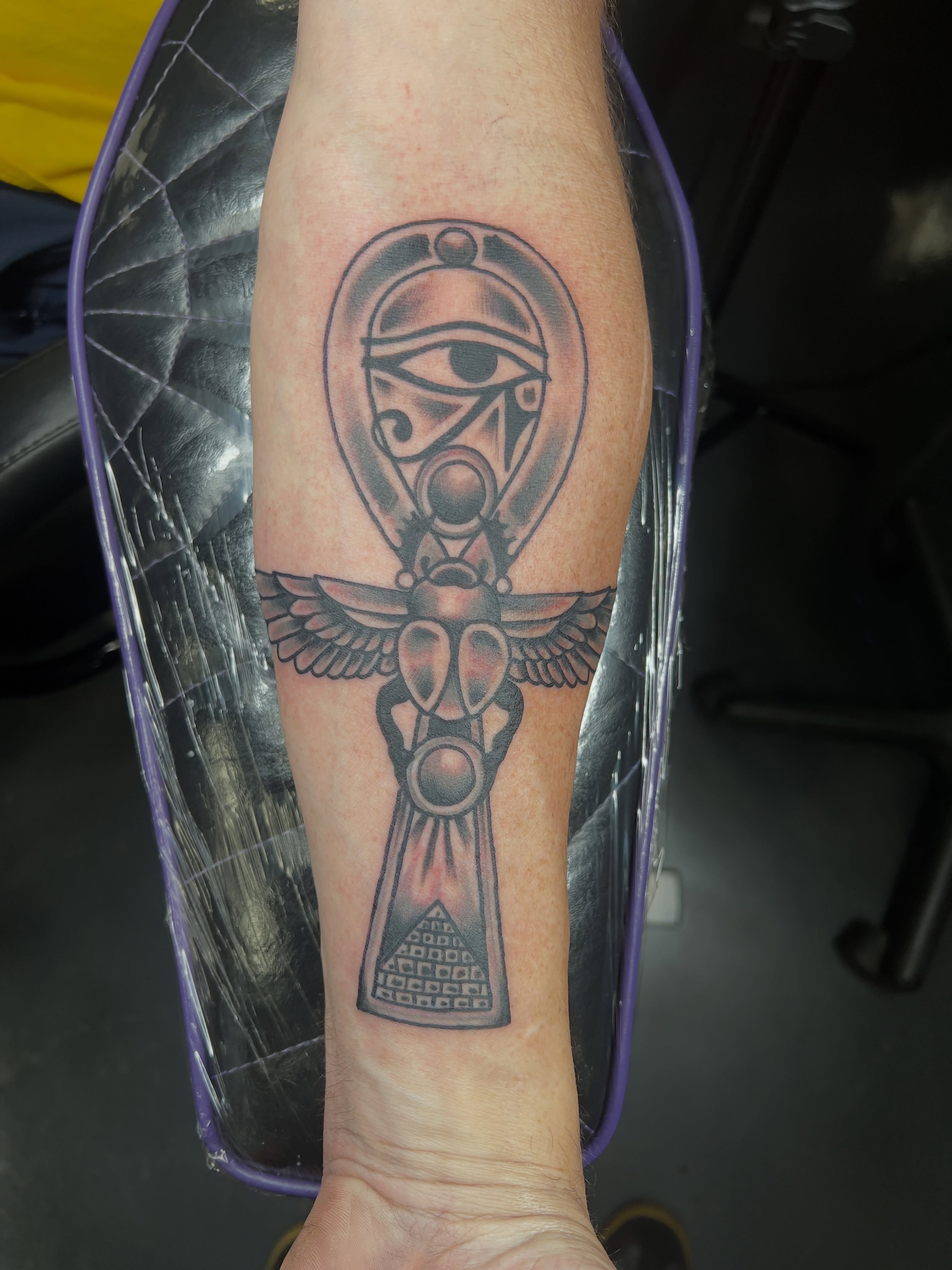 Ancient symbol black and grey tattoo on the forearm by Brian Mock