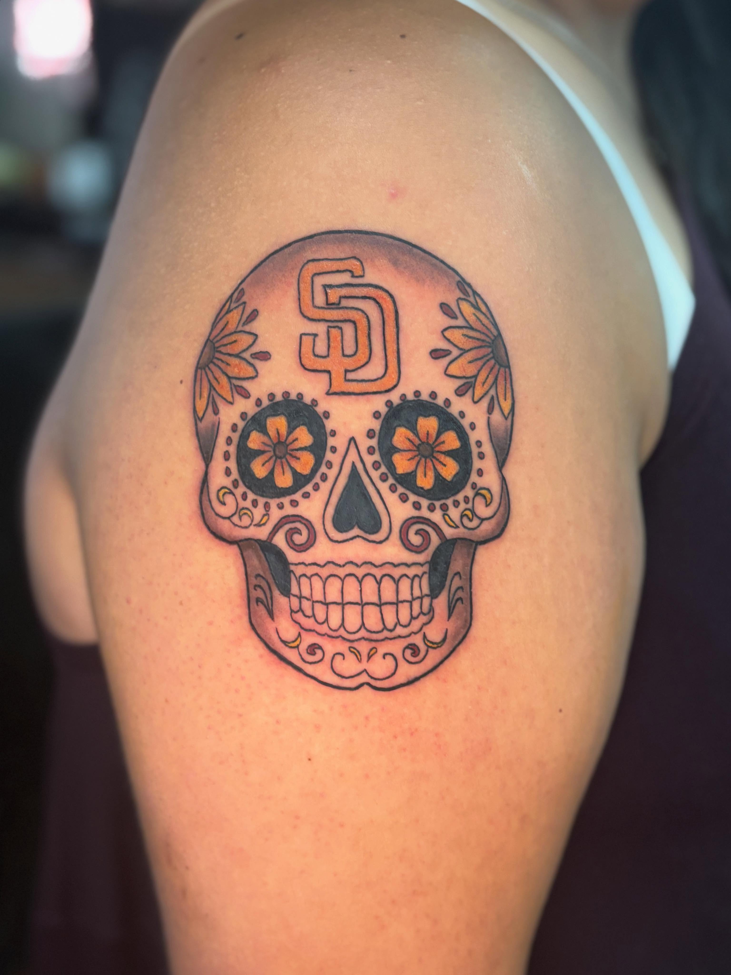 Sugar skull Chicano tattoo on the shoulder by Emma ๐