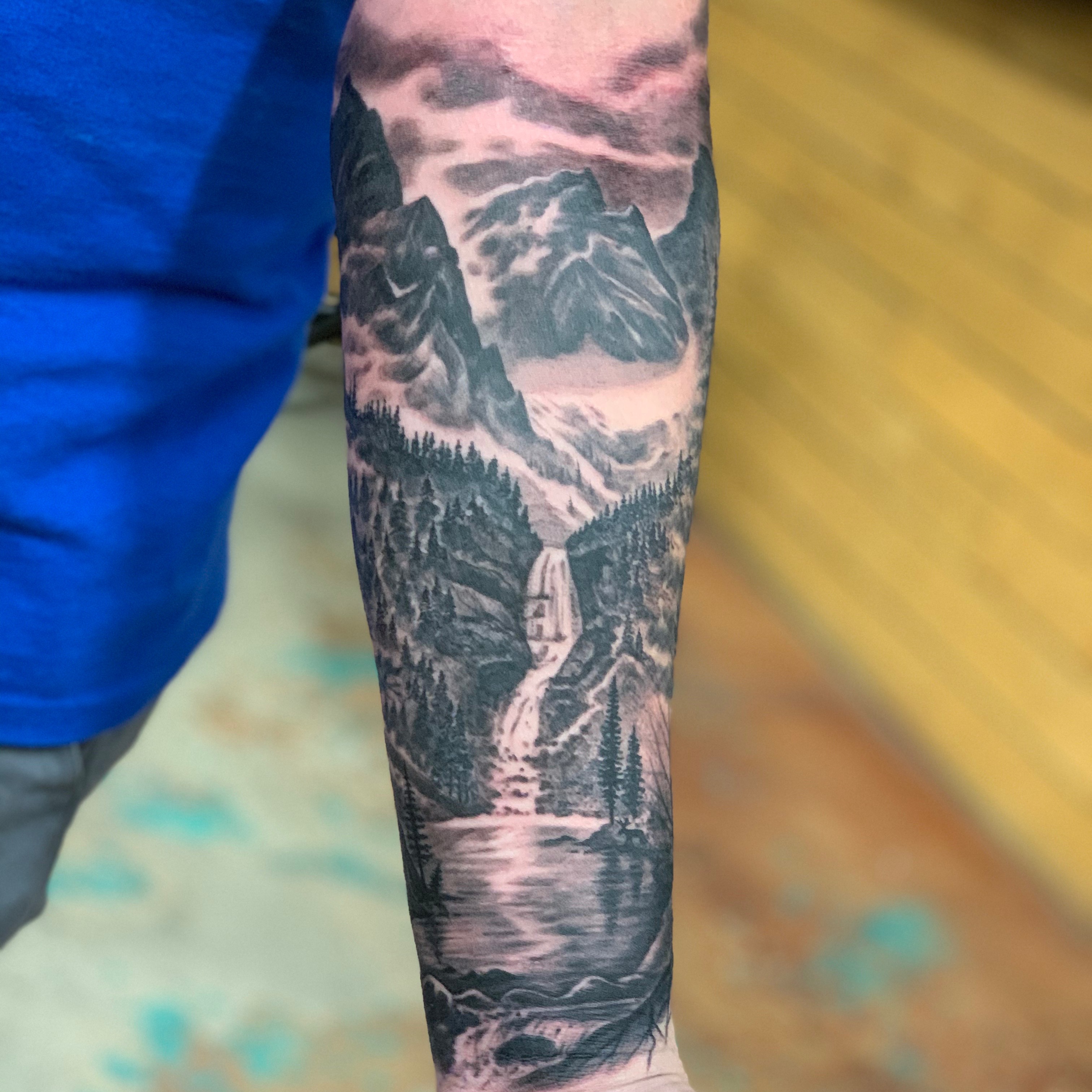 Mountain landscape realism tattoo on the forearm by Jason Oz, Denver, Colorado