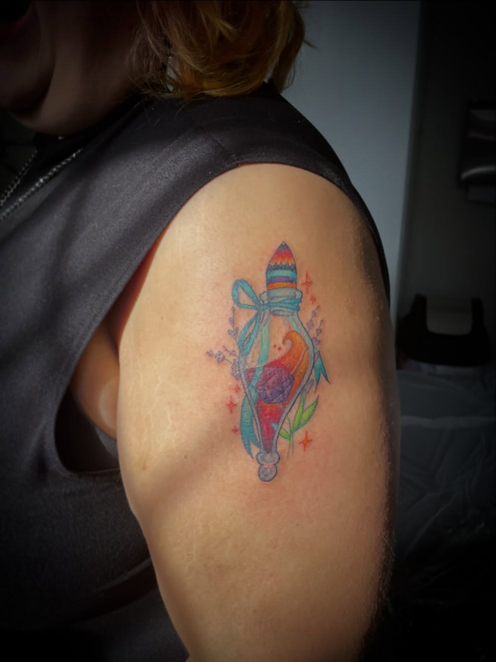 Glass bottle with cork watercolor tattoo on the shoulder by Hannah Copeskey