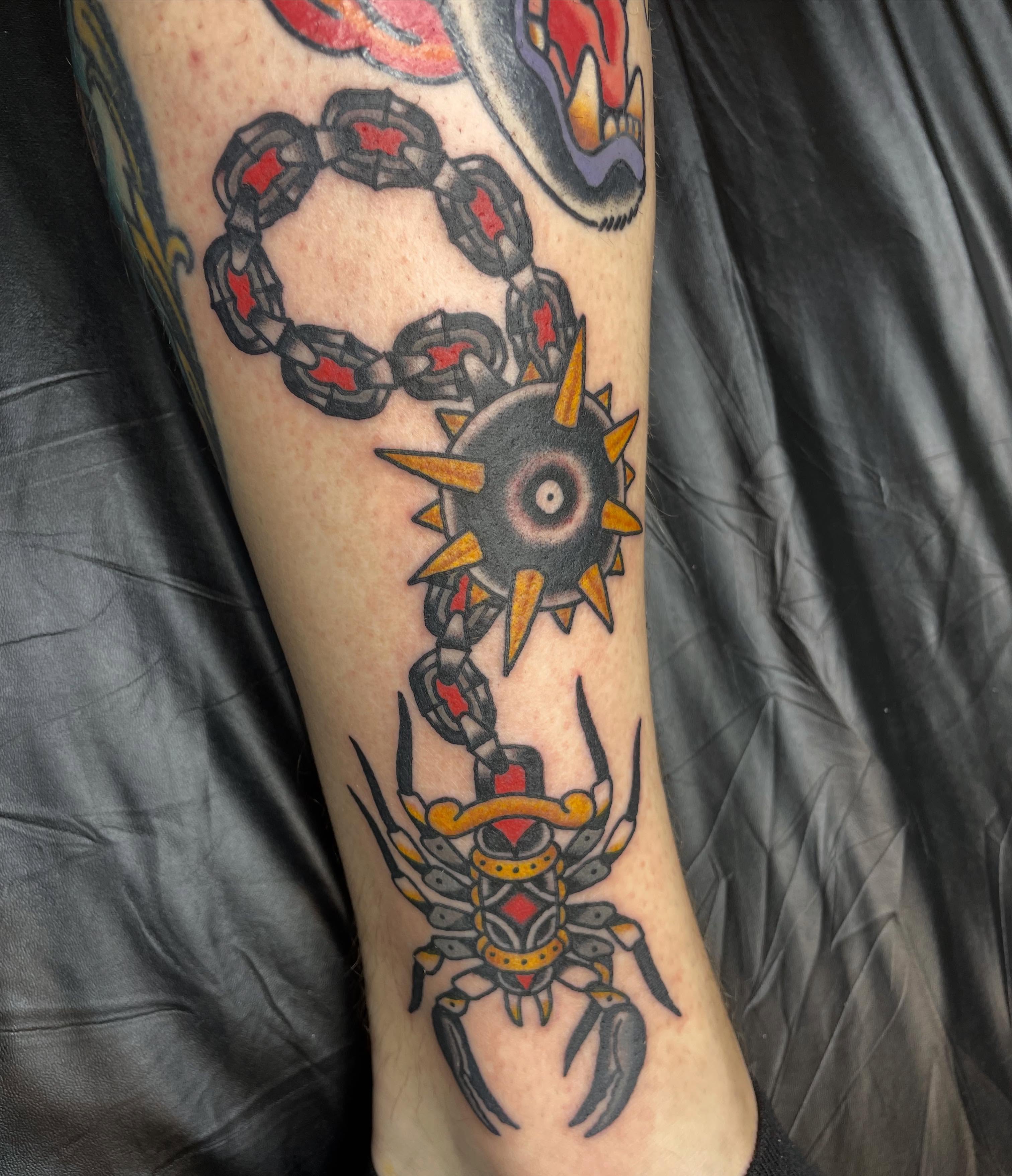 Scorpion and sun American traditional tattoo on the forearm by Mitchell Willard