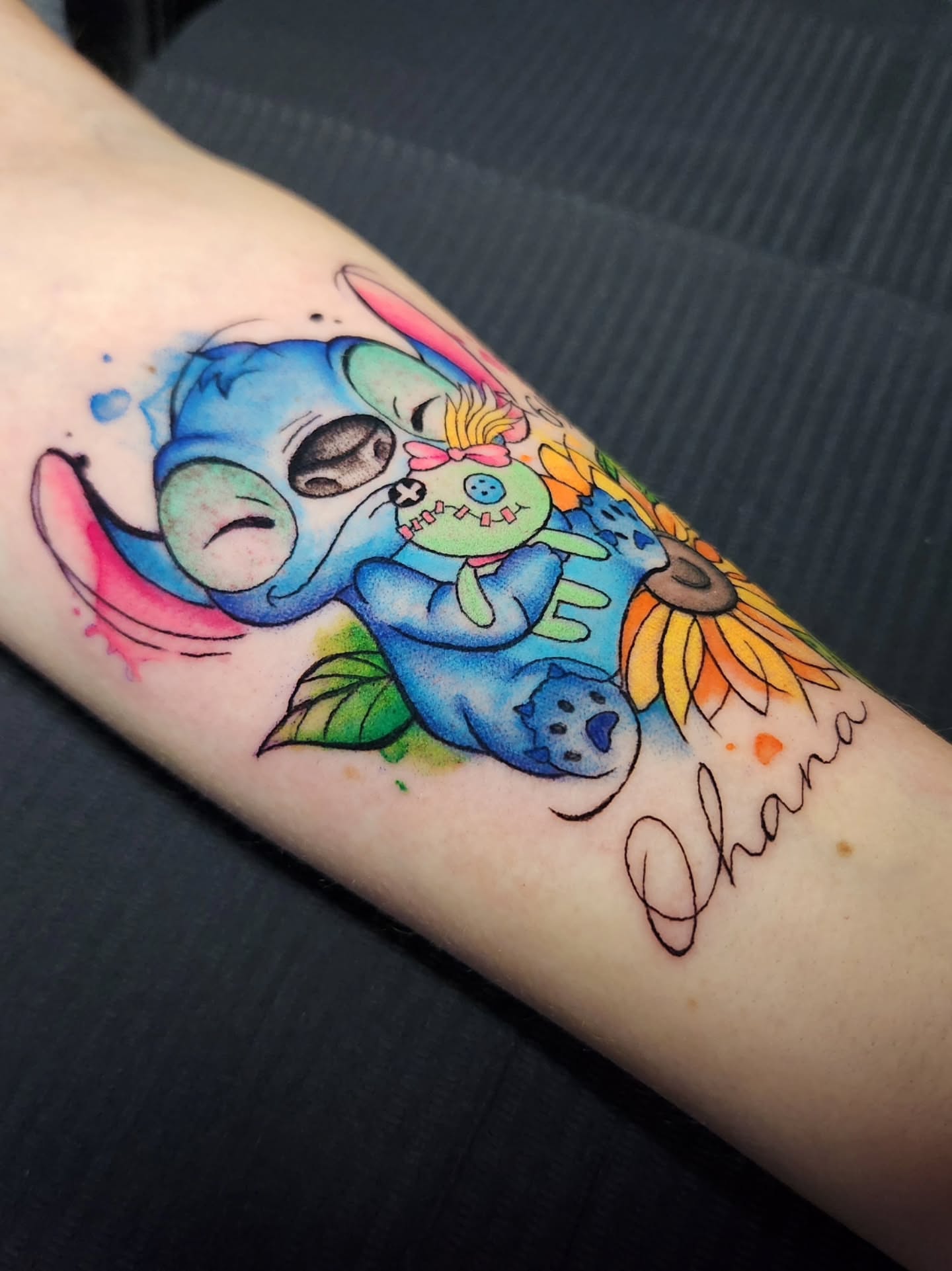 Lilo and Stitch watercolor tattoo on the forearm by Abby Renteria