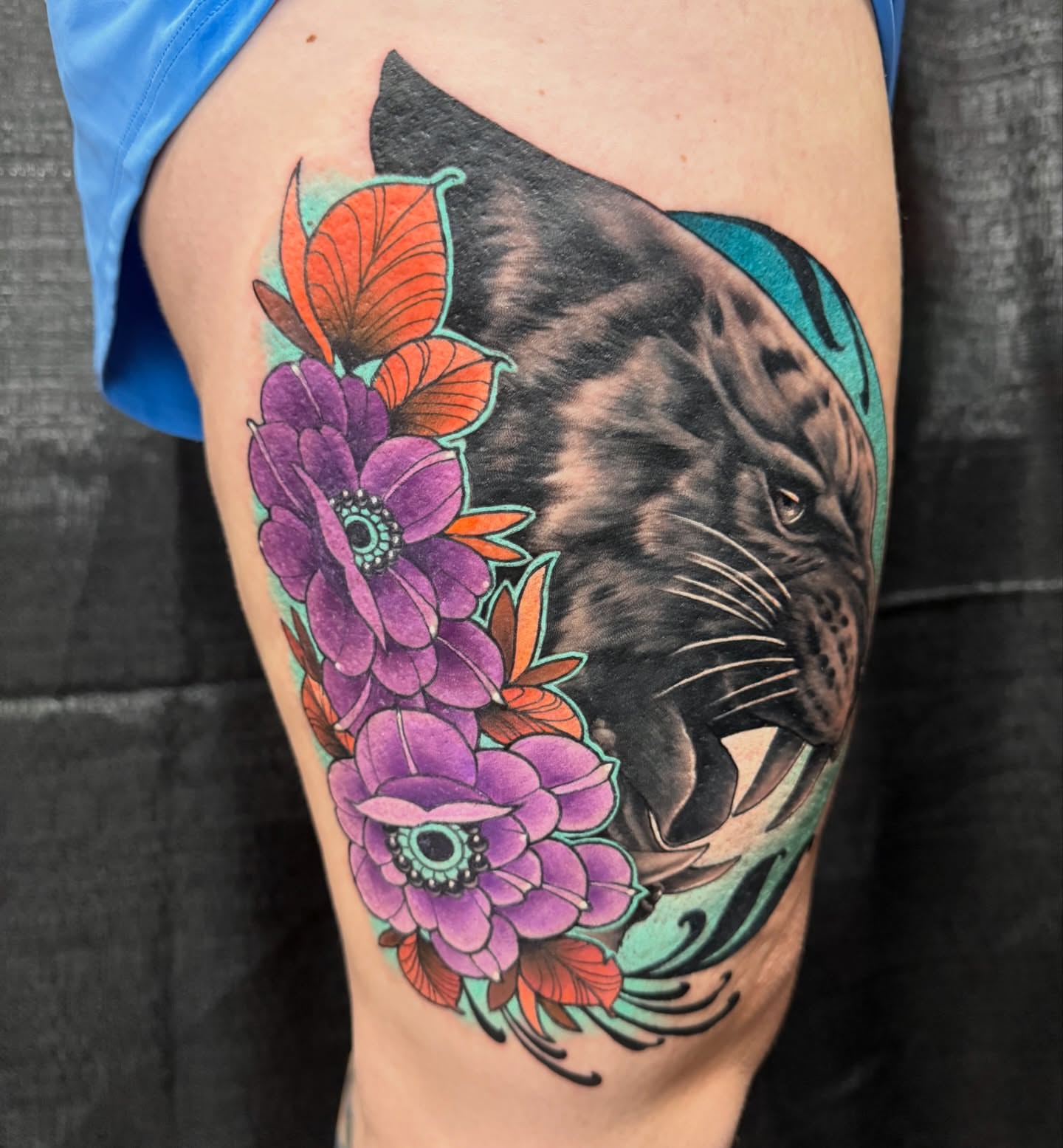 Panther and flowers realism tattoo on the thigh by taylor mills