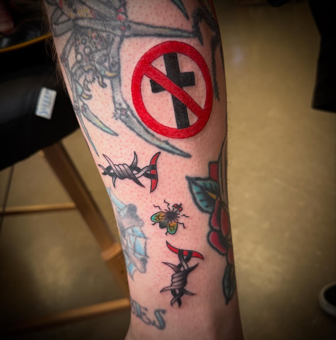 Cross symbol American traditional tattoo on the forearm by ArJay Smith