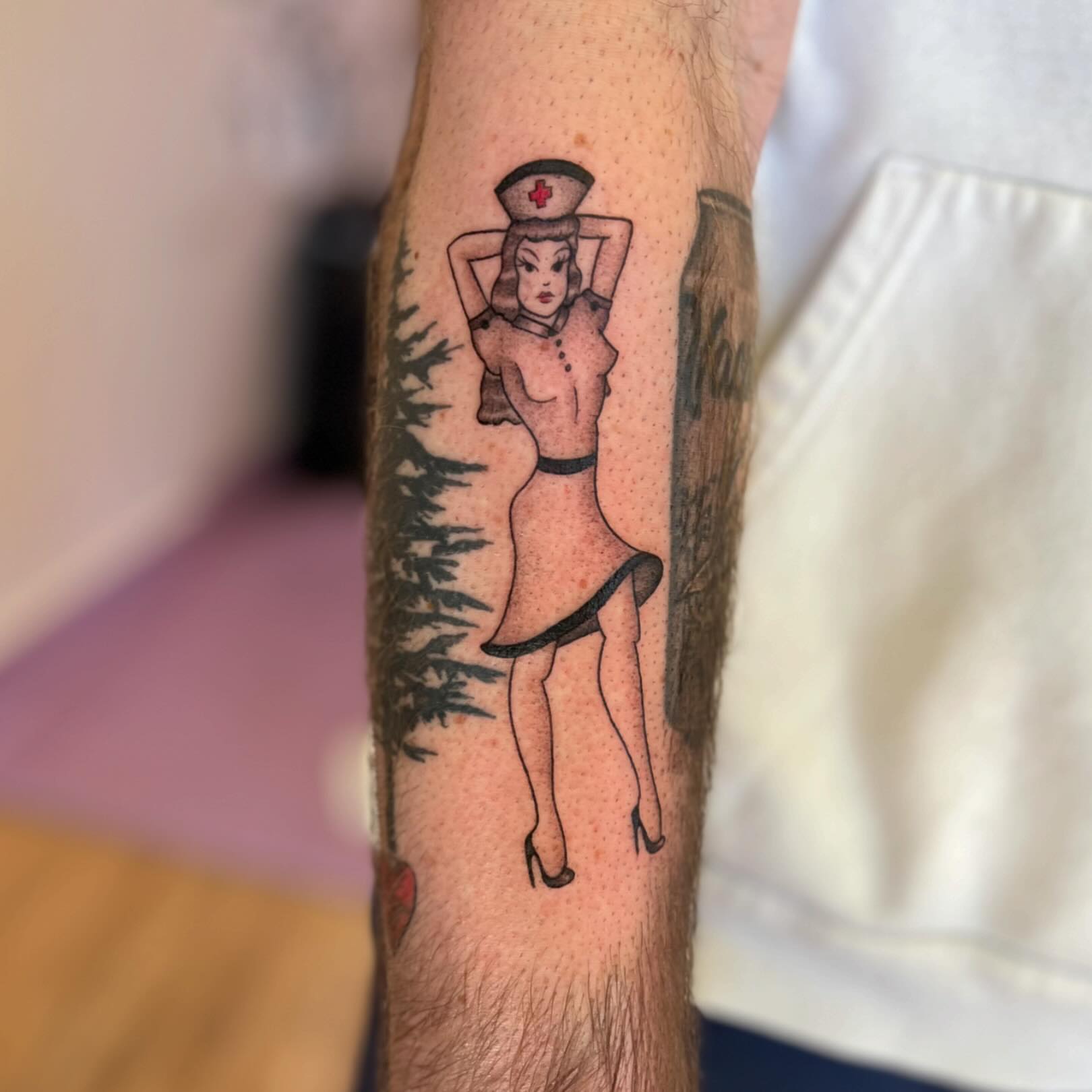 Nurse pin-up American traditional tattoo on the forearm by 🌼DaisyDaiz🕸️
