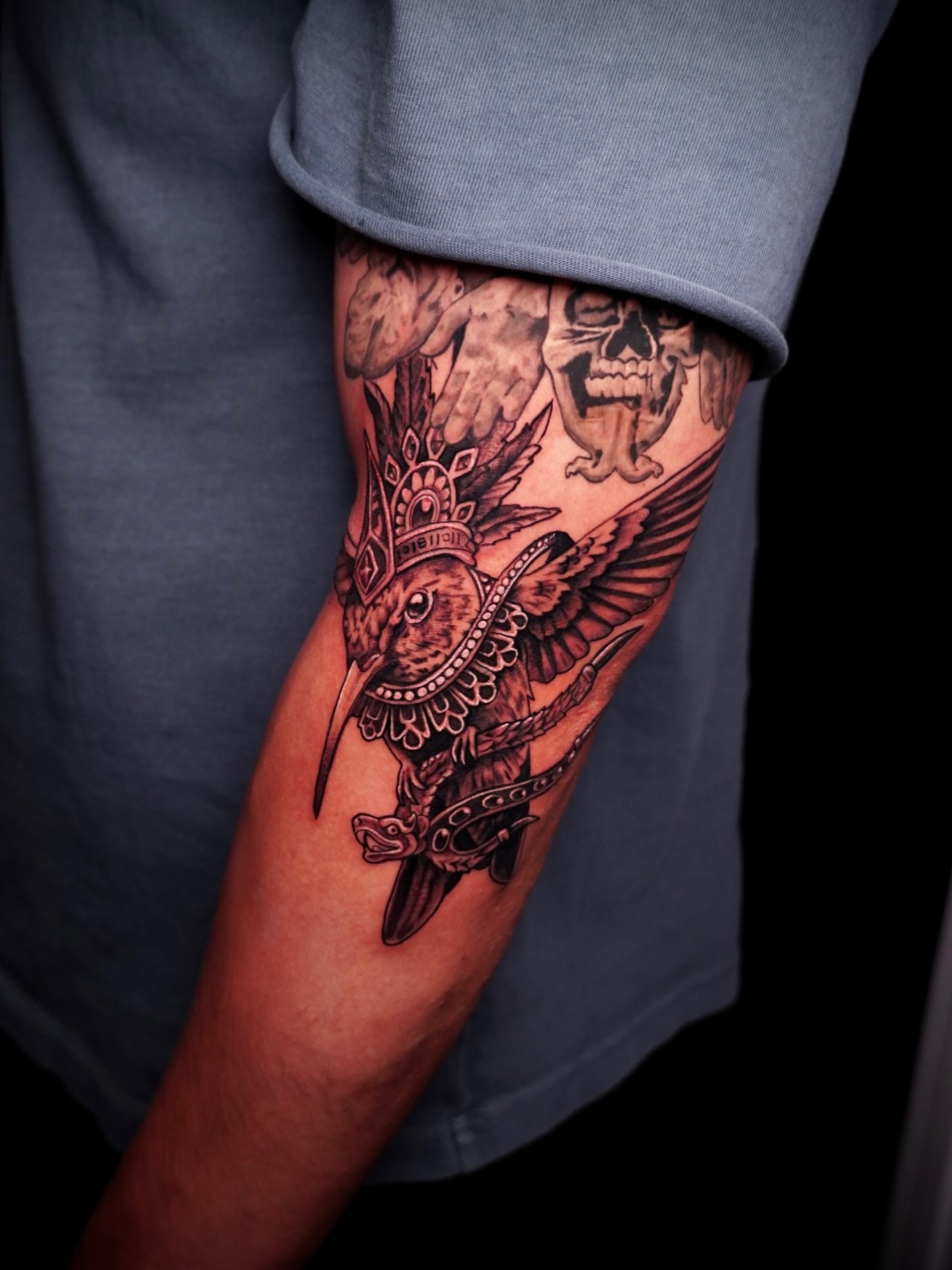 Bird with ornate crown American traditional tattoo on the forearm by Greg Petrali