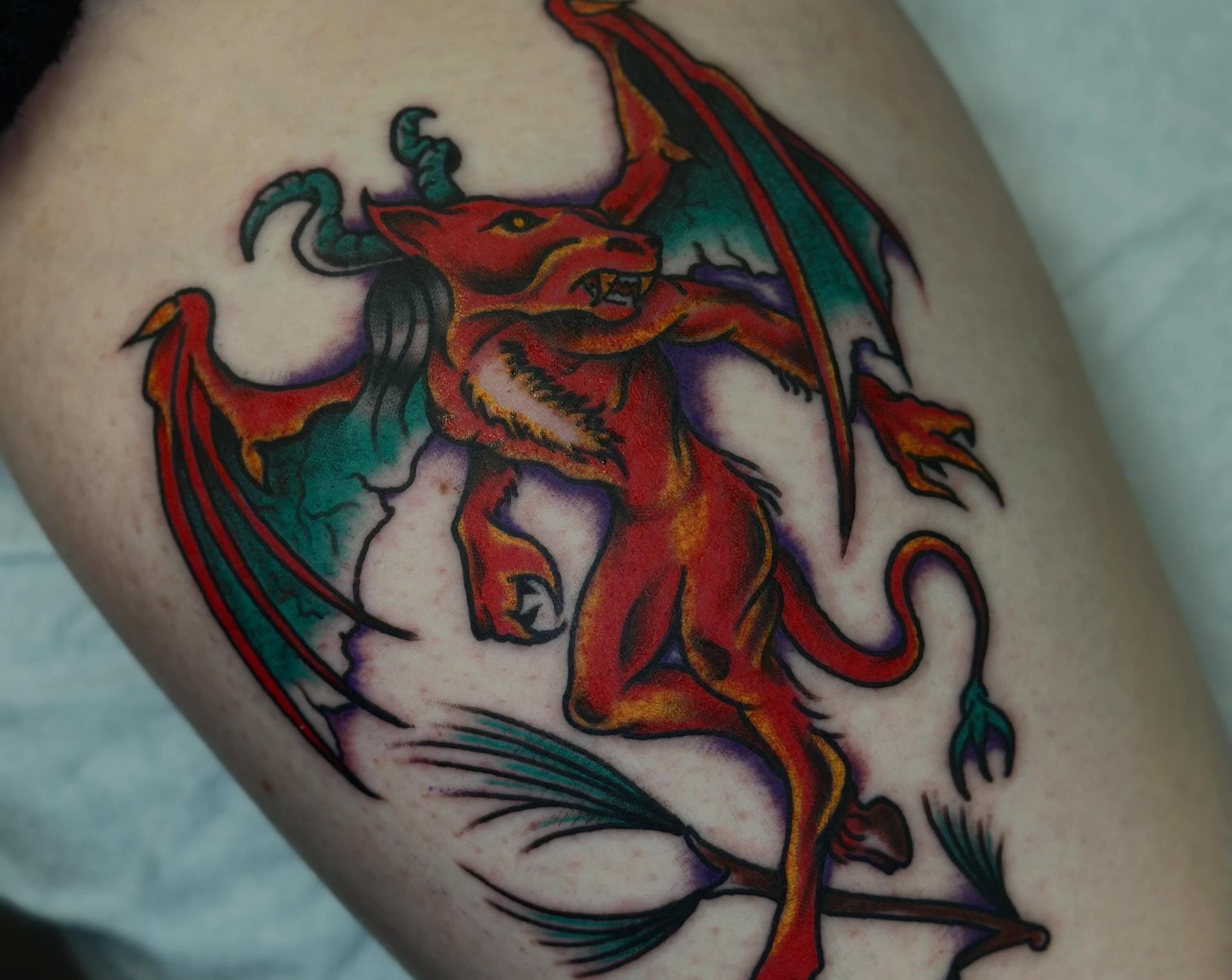 Dragon American traditional tattoo on the thigh by Olive Kelley
