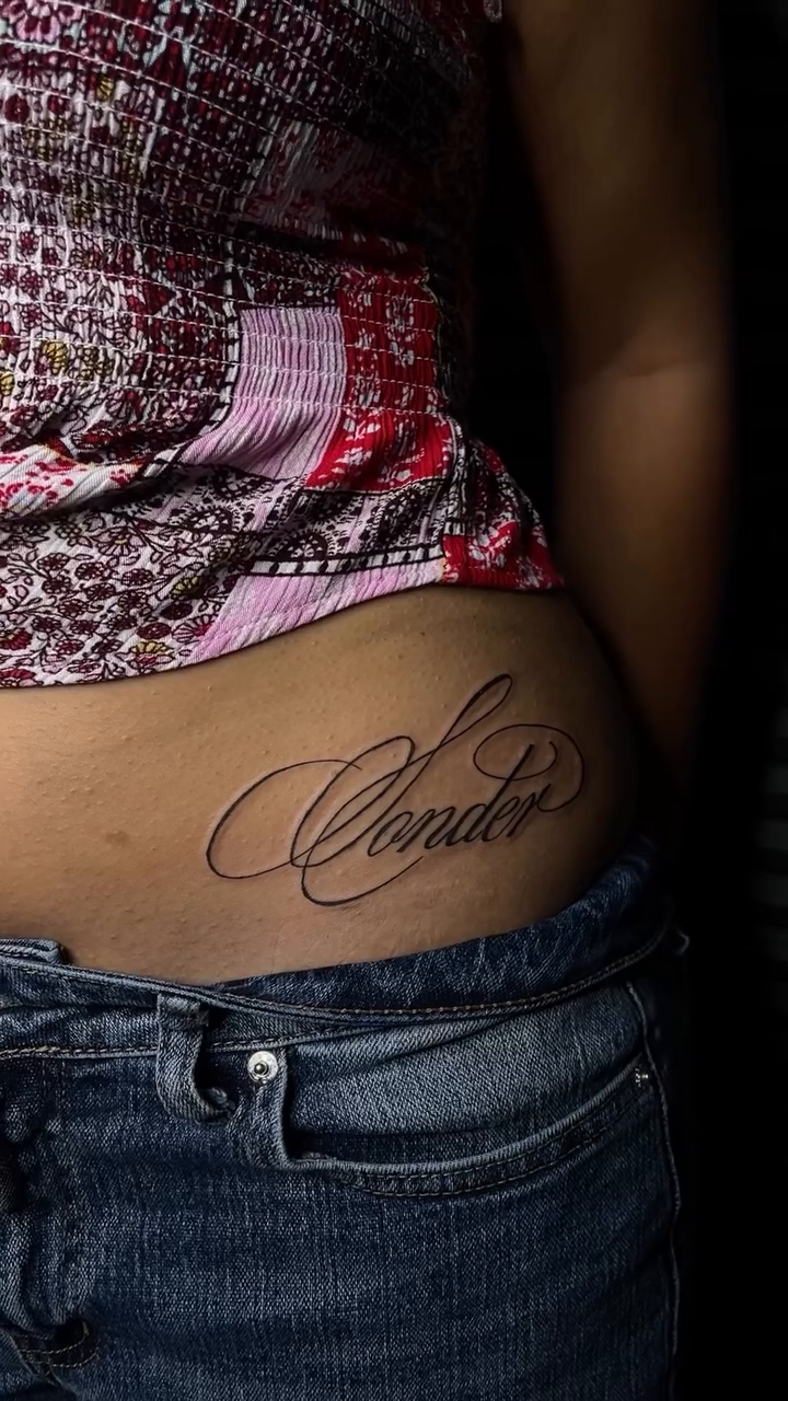 The word "Wonder" lettering script tattoo by clarissa