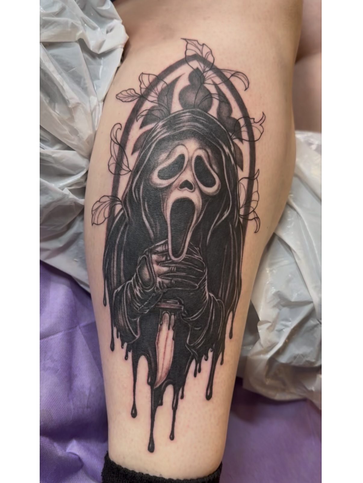 Scream mask realism tattoo on the thigh by Maggie George