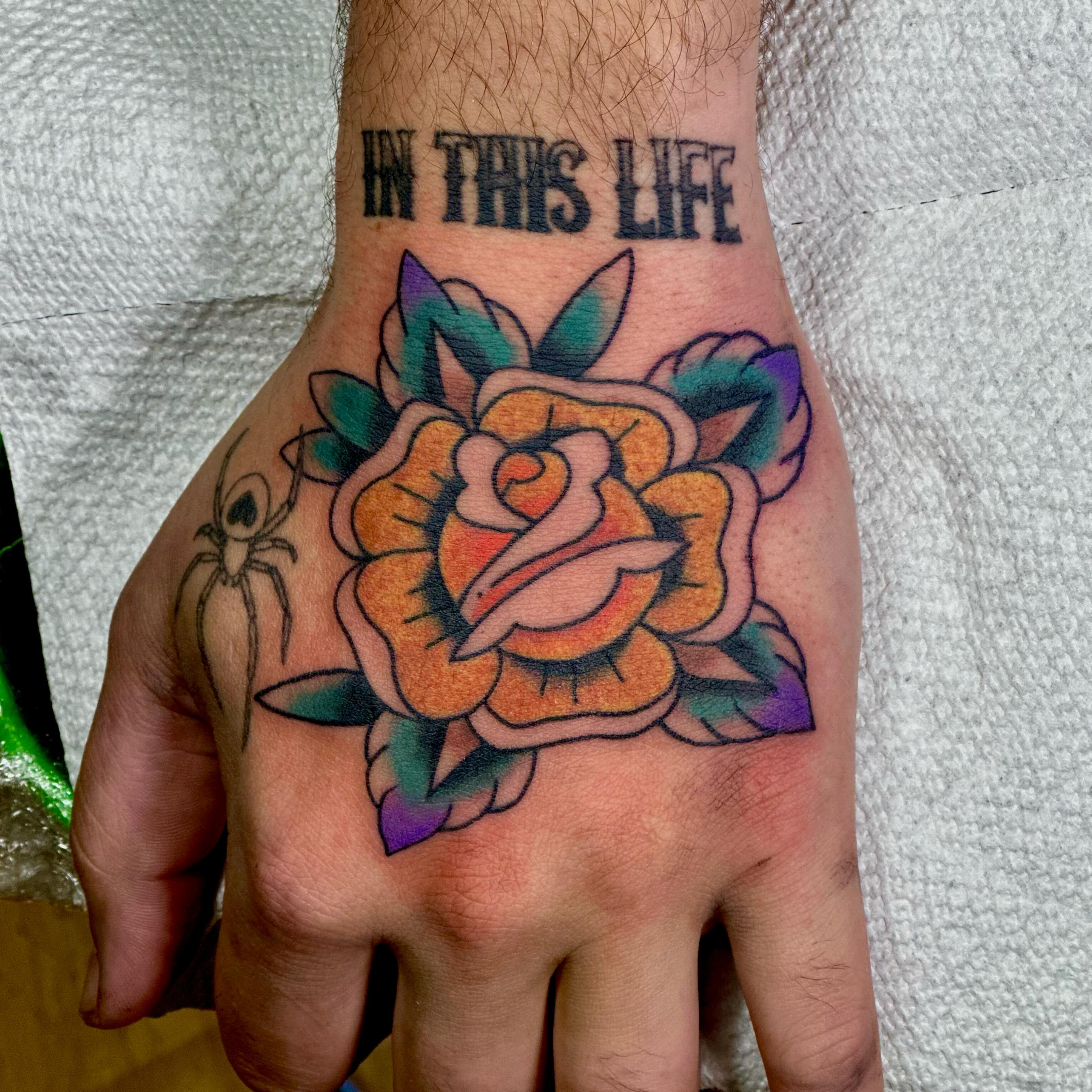 Rose American traditional tattoo on the hand by Dylan Curry