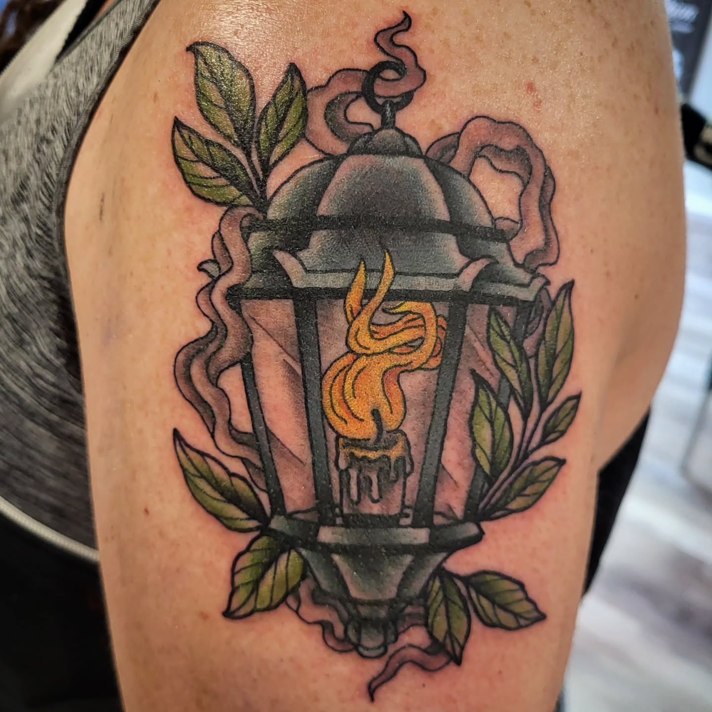 Lantern with flame American traditional tattoo on the upper arm by Sloan Smith