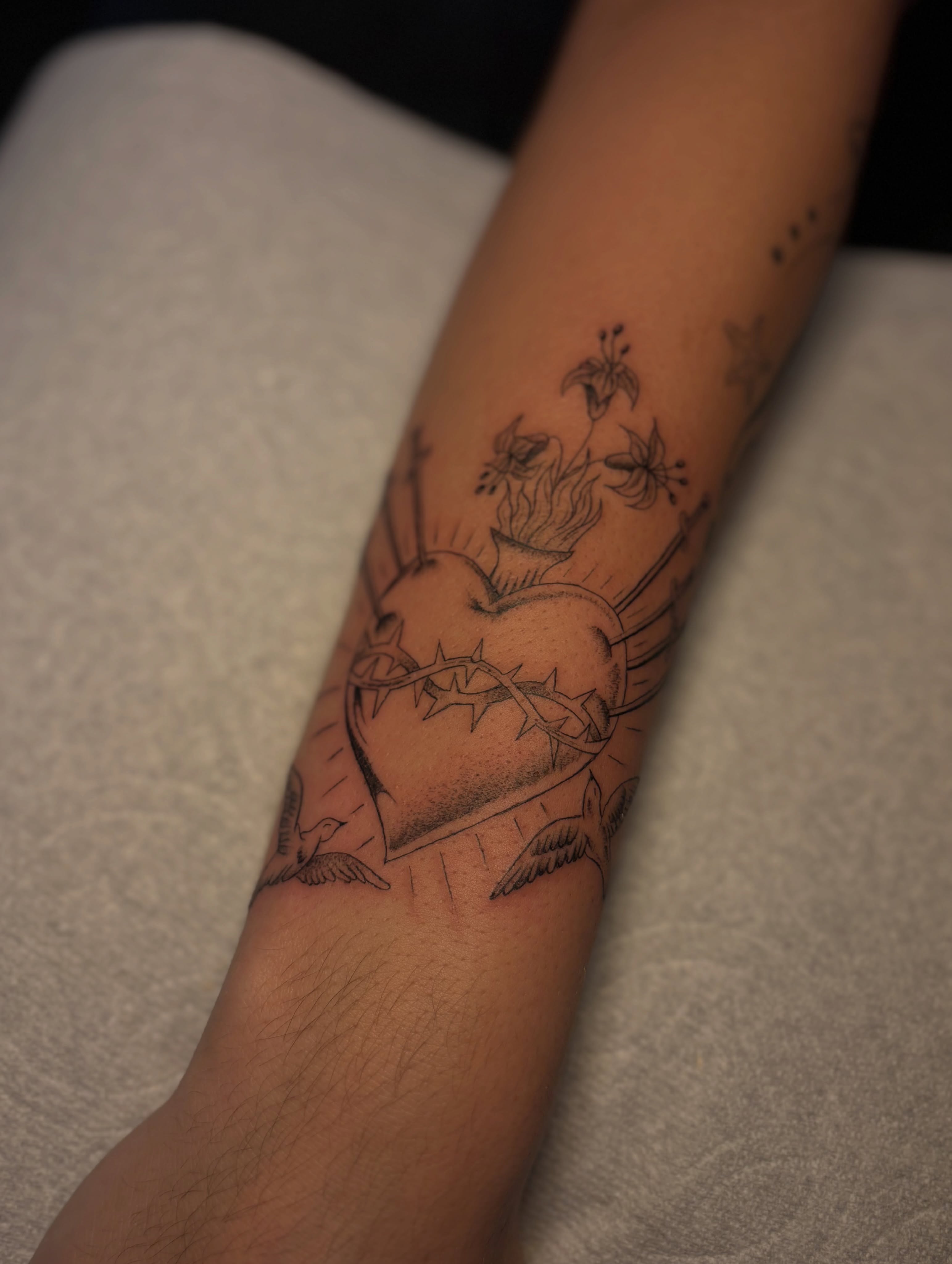 Heart with crown of thorns black and grey tattoo on the forearm by the ink witch ๐ฎ๐ค๐
