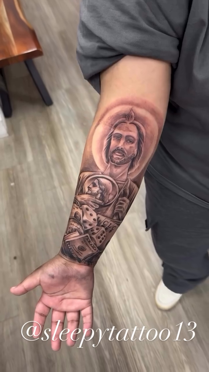Jesus with dice and skulls Chicano tattoo on the forearm by Brian Cruz Garcia