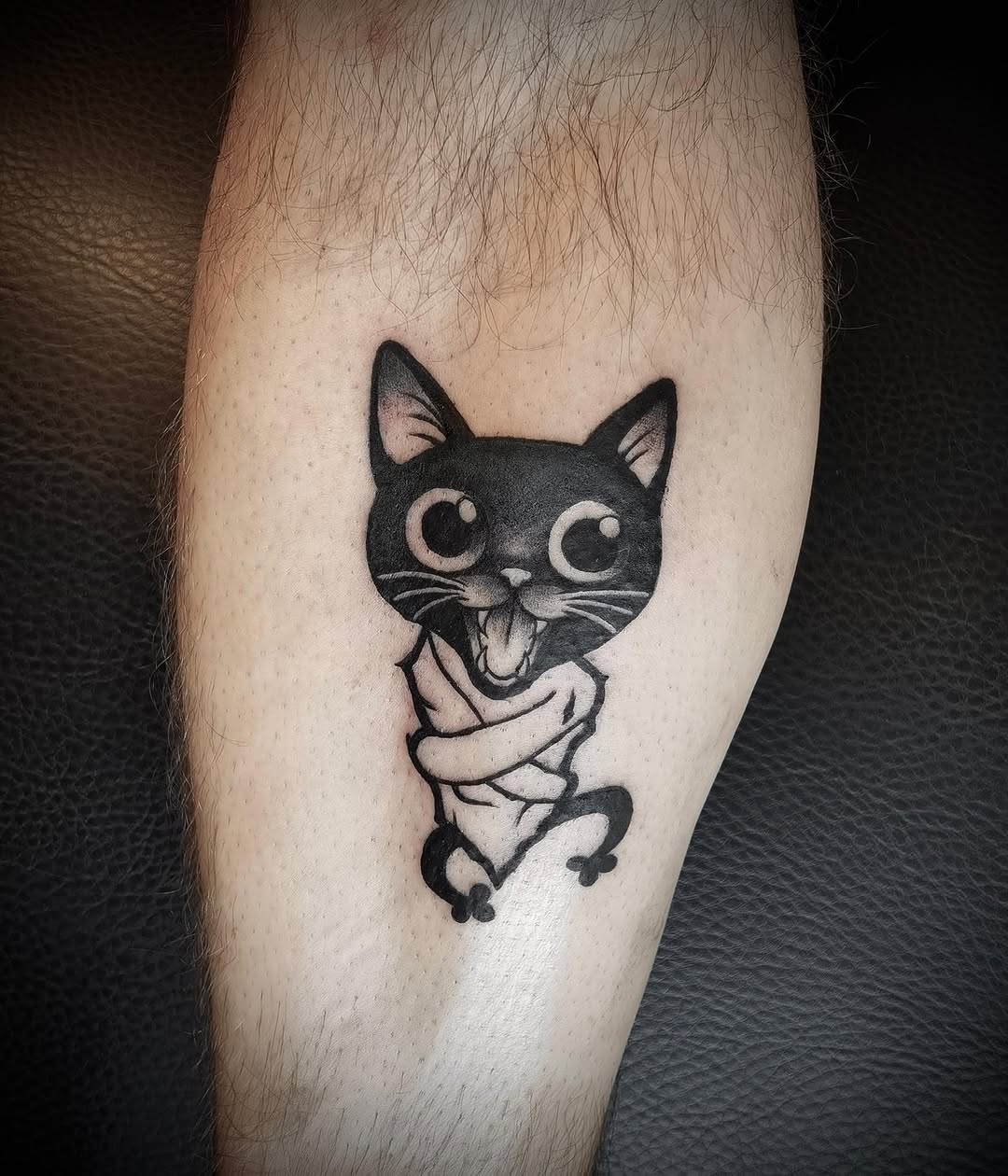 Cat in straitjacket realism tattoo on the forearm by Ink of Winchester