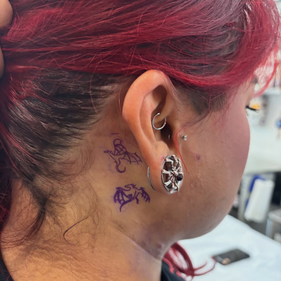 Bat American traditional tattoo on the neck by Weho Tattoo Artist Lupe