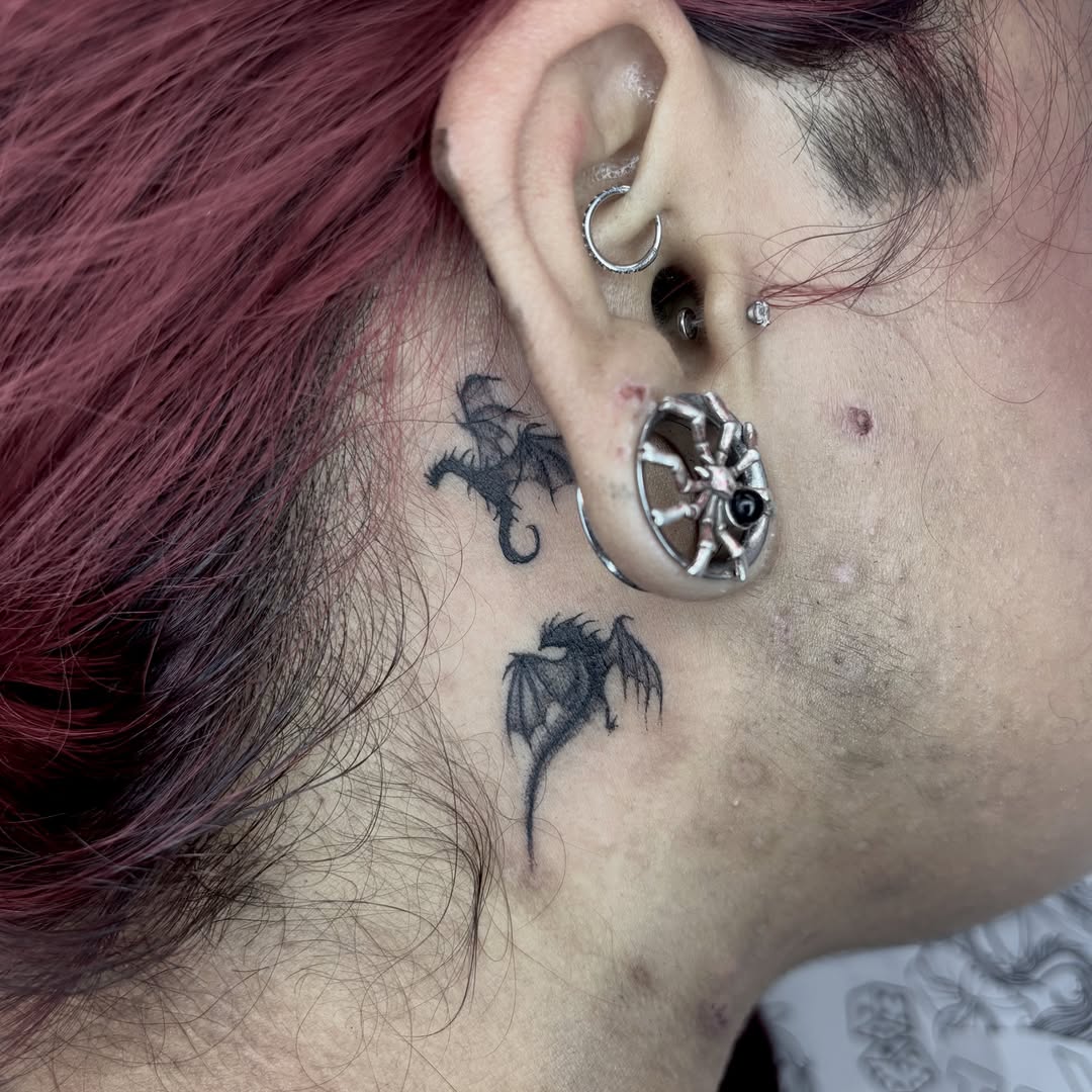 Dragons black and grey tattoo on the neck by Weho Tattoo Artist Lupe