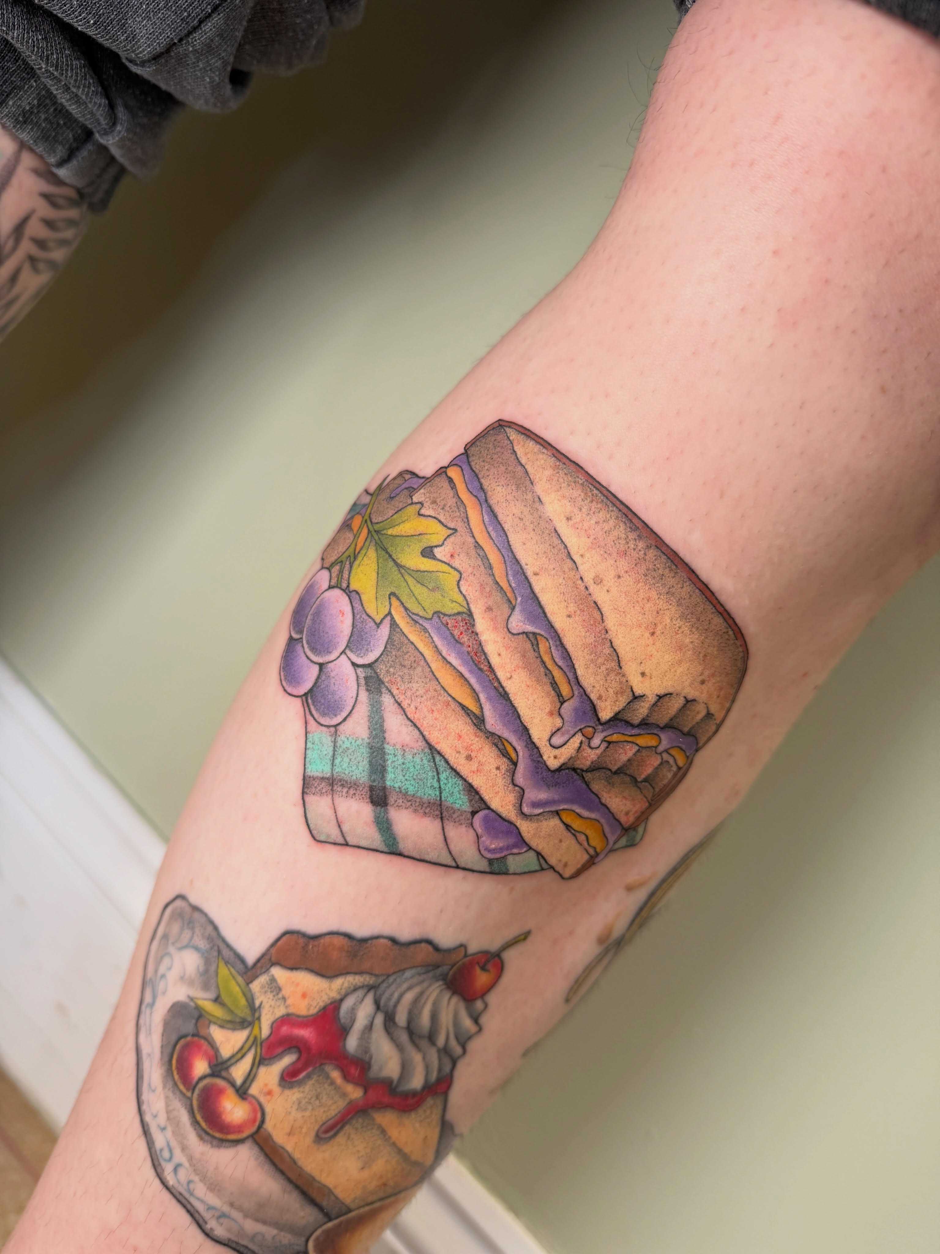 Sandwich and grapes American traditional tattoo on the forearm by Koryn Donnelly